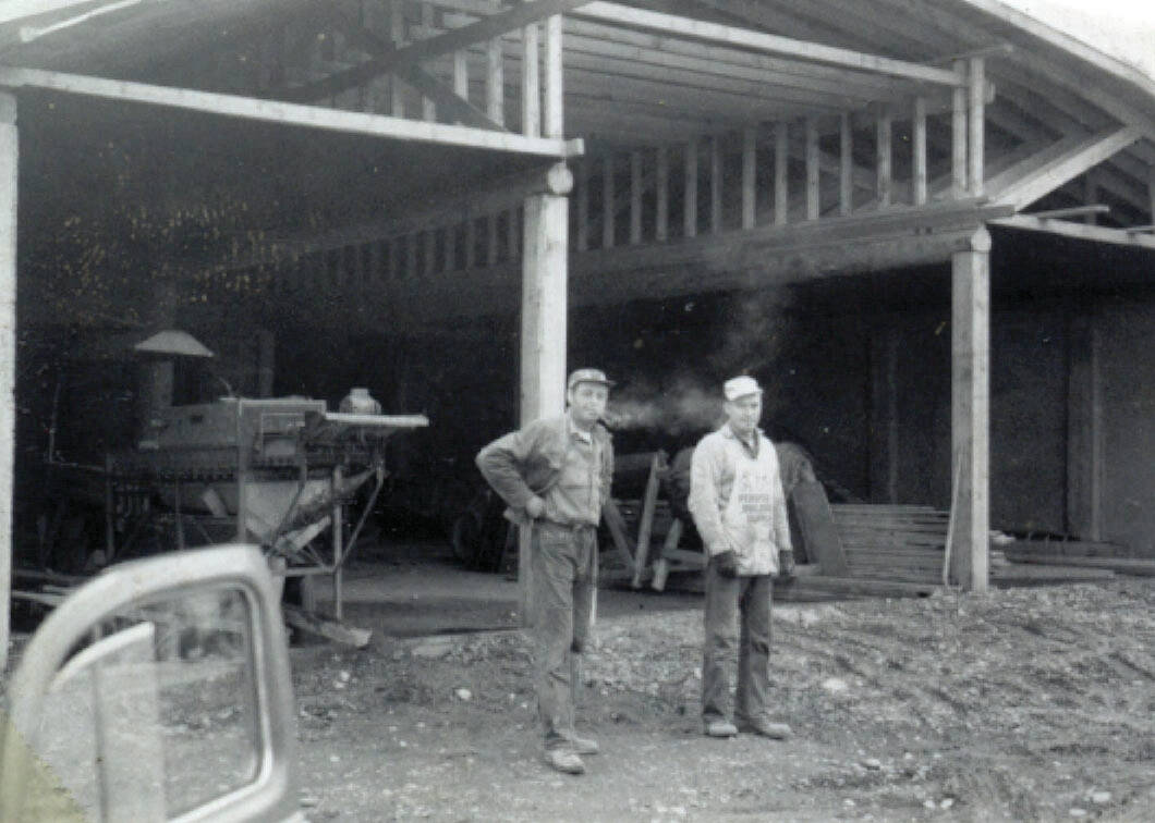 Cheechako News photo courtesy of the KPC historic photo repository
Larry Lancashire, left with his pipe, and his helper Charles Easton, pause during the construction of Lancashire’s potato barn in 1961.