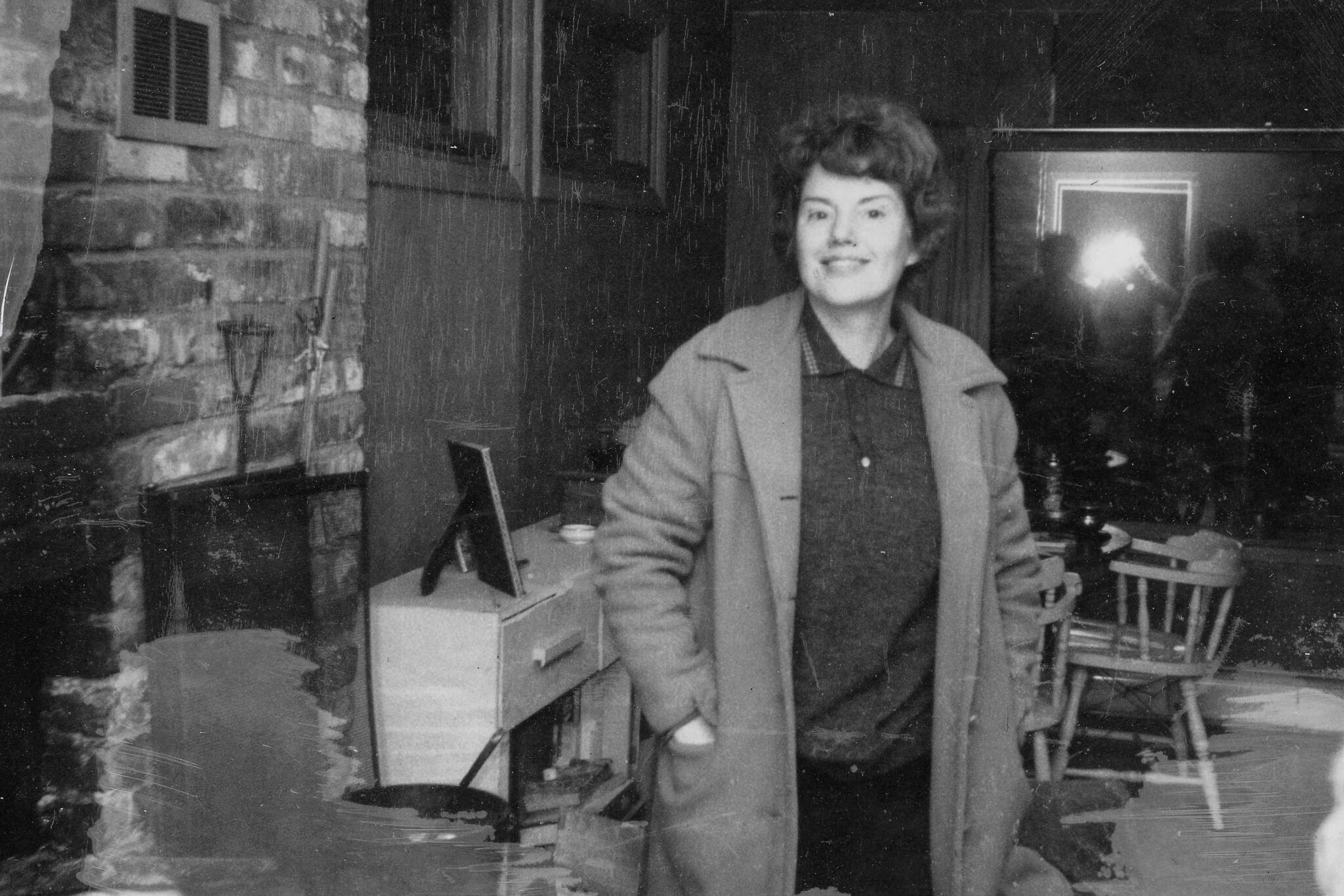 Rusty Lancashire smiles for the camera in the frame house that in the late 1950s replaced the Lancashires’ original homestead log cabin. (Photo courtesy of the Lancashire Family Collection)