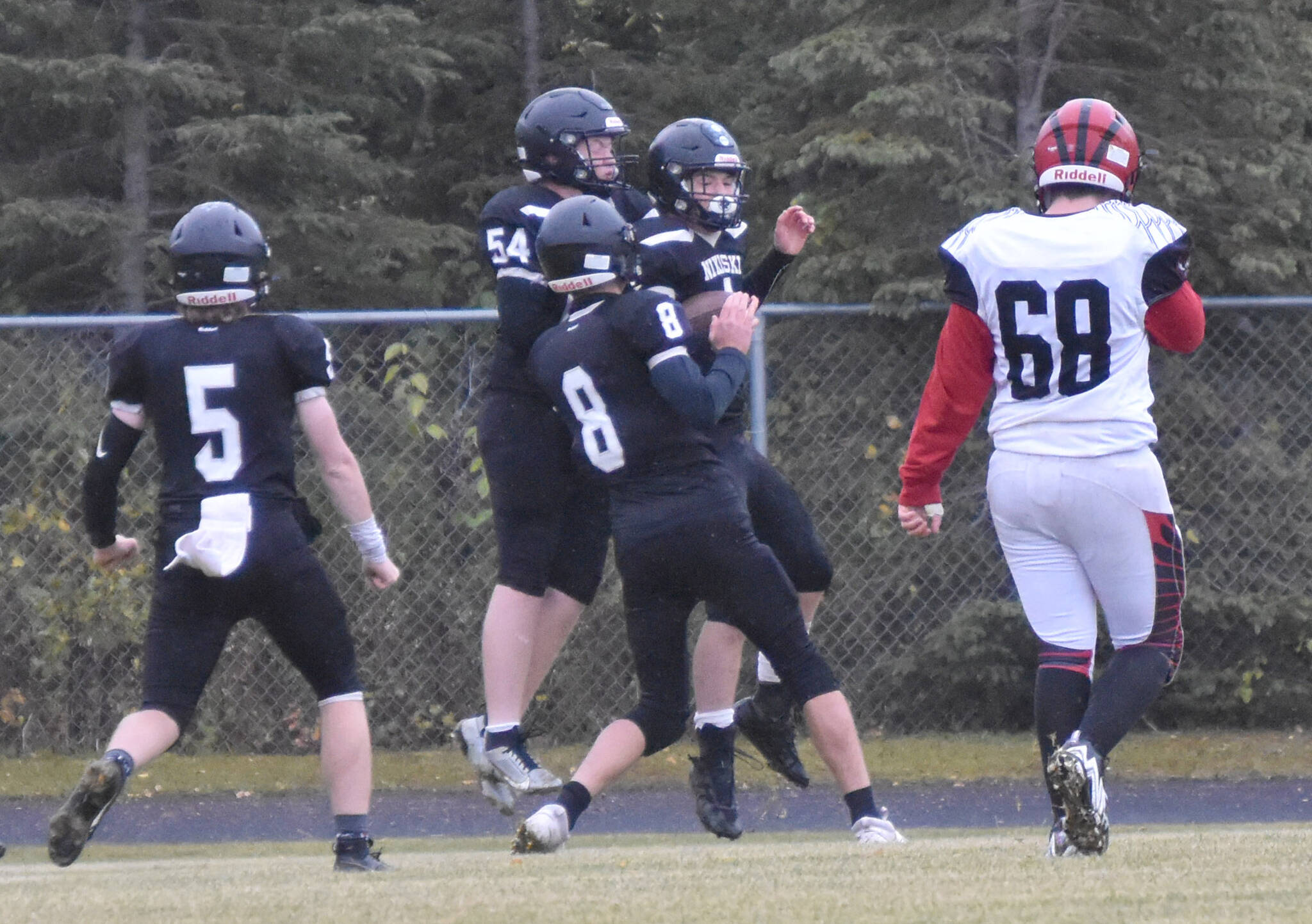 Nikiski’s Everett Chamberlain, Lynn Deveer, Seth Payne and Oliver Parrish celebrate the touchdown run of Parrish on Saturday, Sept. 30, 2023, at Nikiski Middle-High School in Nikiski, Alaska. (Photo by Jeff Helminiak/Peninsula Clarion)