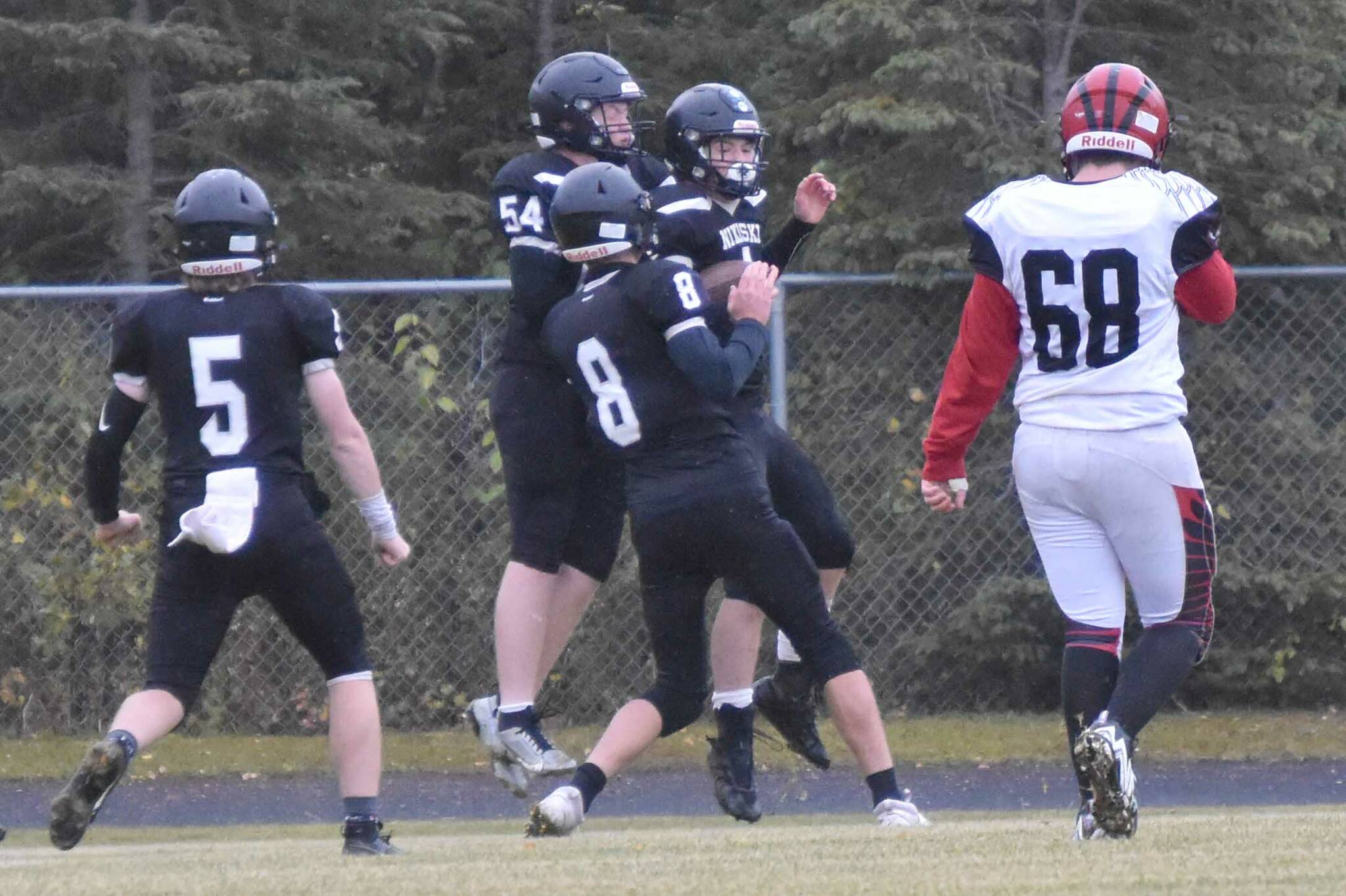 Nikiski's Everett Chamberlain, Lynn Deveer, Seth Payne and Oliver Parrish celebrate the touchdown run of Parrish on Saturday, Sept. 30, 2023, at Nikiski Middle-High School in Nikiski, Alaska. (Photo by Jeff Helminiak/Peninsula Clarion)