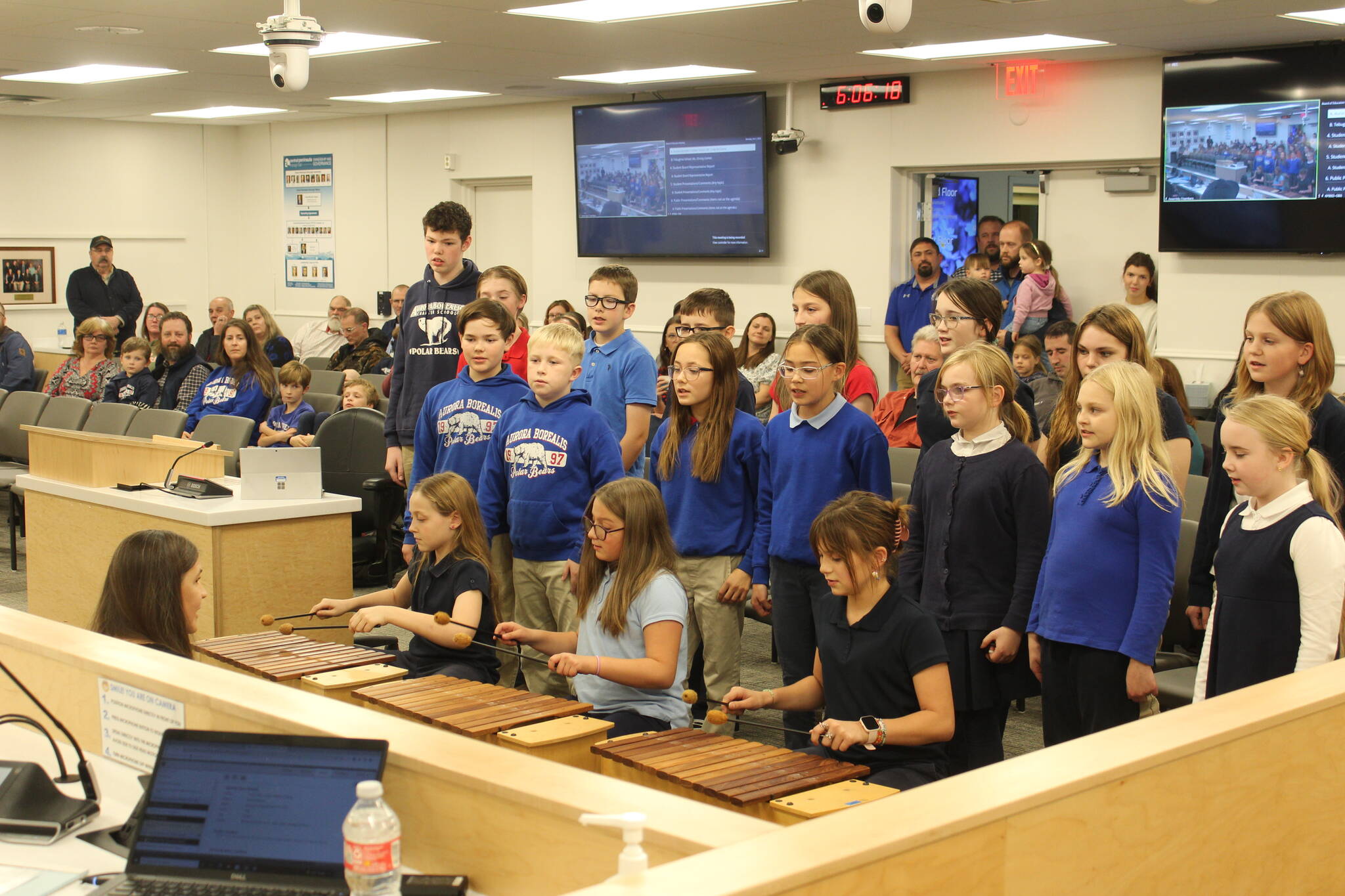 Aurora Borealis Charter School Art and Music Teacher Eleanor Van Sickle leads students in a performance of "Autumn Canon," a Hungarian song at a meeting of the Kenai Peninsula Borough School District Board of Education meeting on Monday, Oct. 2, 2023 in Soldotna, Alaska. (Ashlyn O'Hara/Peninsula Clarion)