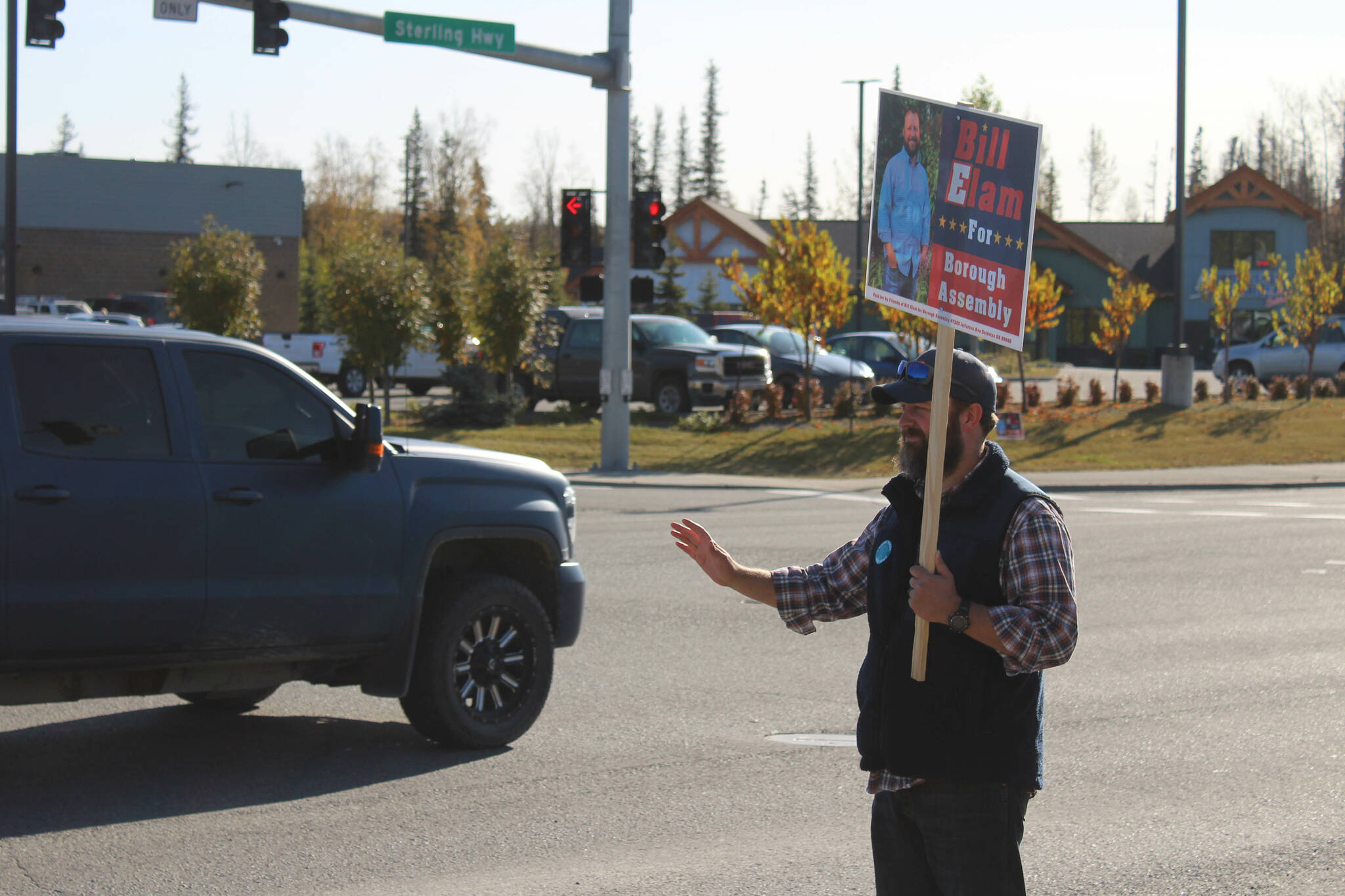 Kenai Peninsula Borough Assembly Candidate Bill Elam waves signs on election day on Tuesday, Oct 3, 2023, in Soldotna, Alaska. (Ashlyn O’Hara/Peninsula Clarion)