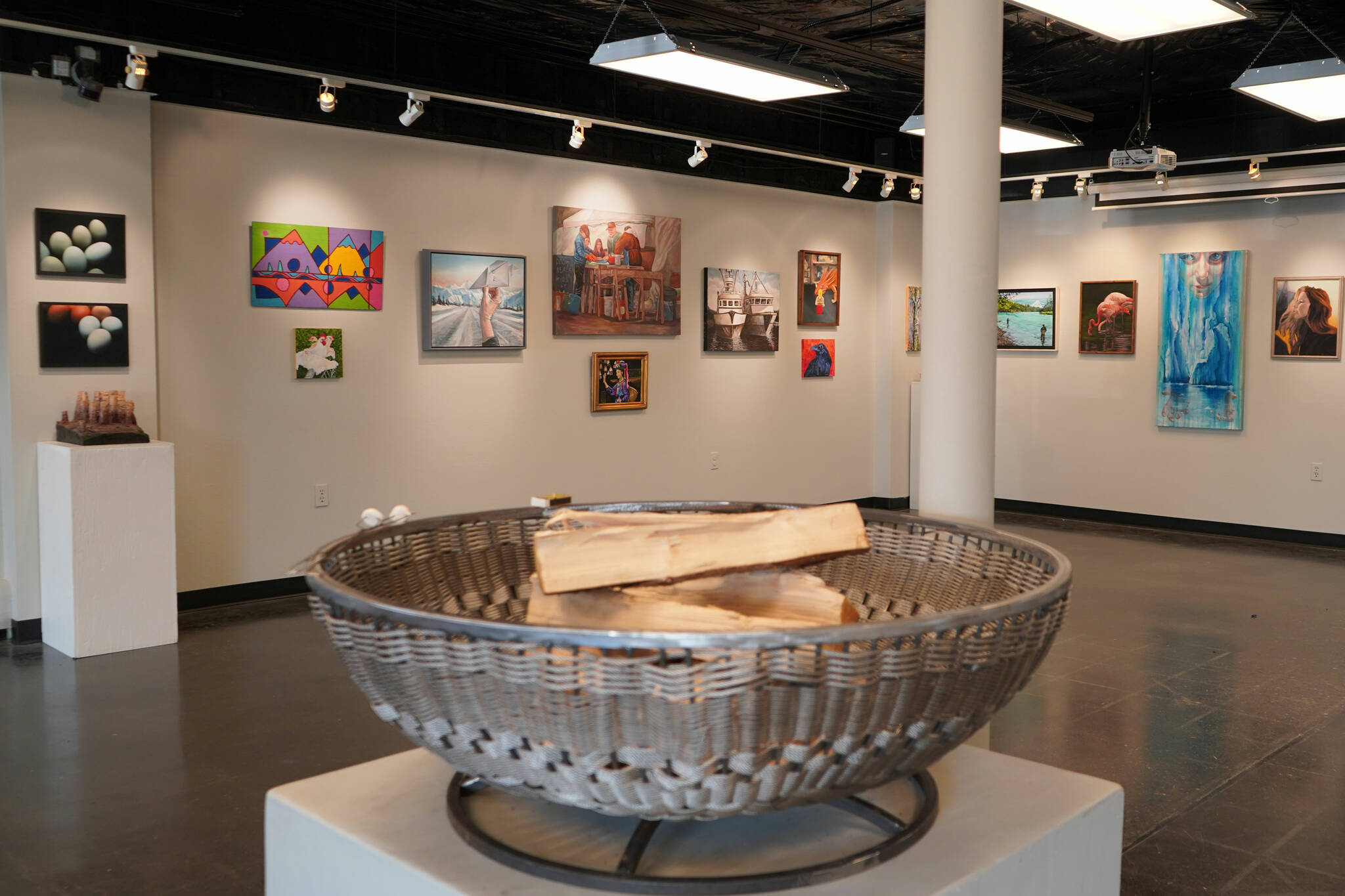 A fire pit crafted by C.O. Rudstrom stands at the center of the gallery, in front of several other pieces included in the Biennial Judged Show at the Kenai Art Center in Kenai, Alaska, on Wednesday, Oct. 4, 2023. (Jake Dye/Peninsula Clarion)