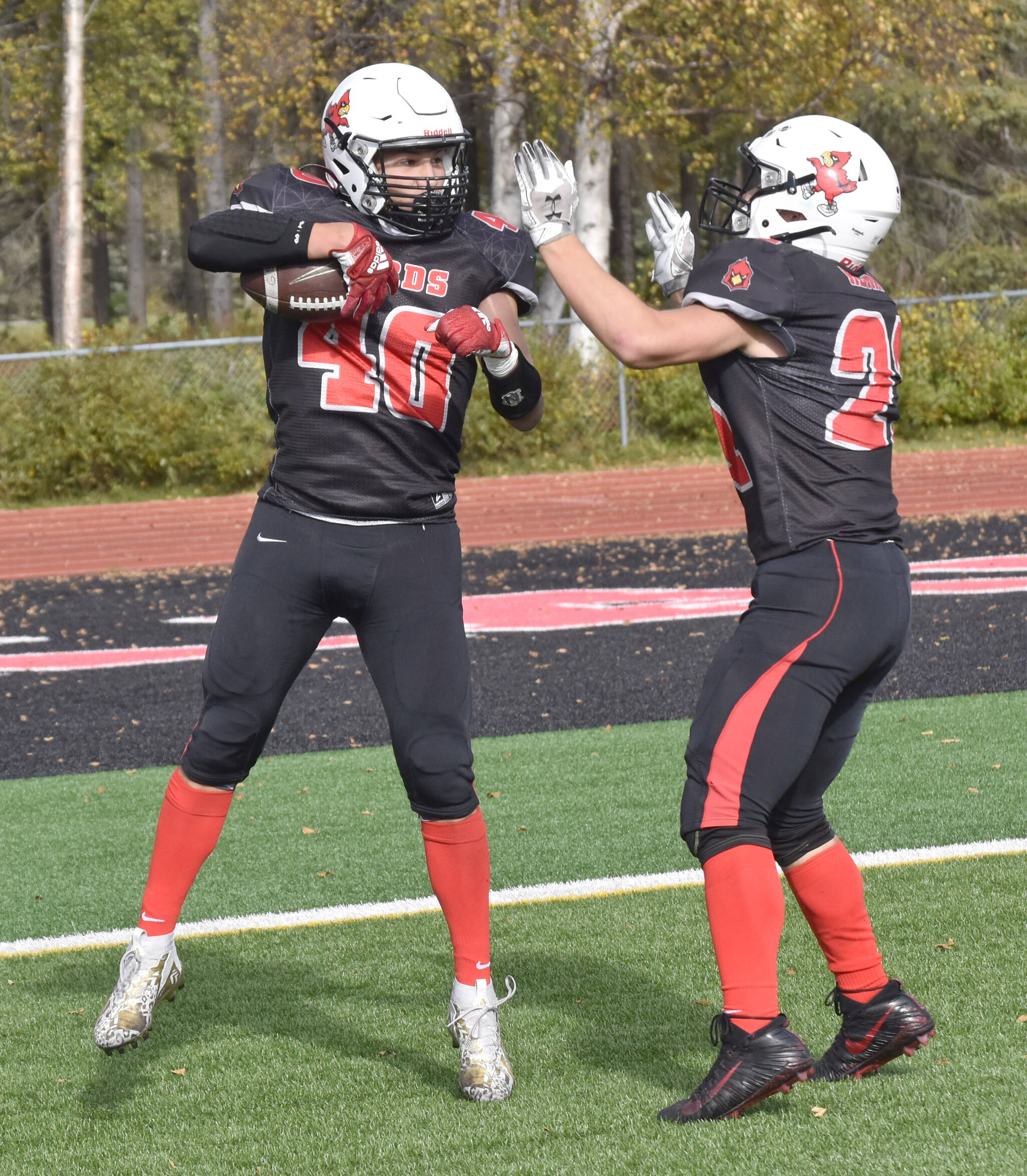 Kenai Centrals Bobby Hayes celebrates his touchdown with William Wilson on Saturday, Sept. 23, 2023, at Ed Hollier Field at Kenai Central High School in Kenai, Alaska. (Photo by Jeff Helminiak/Peninsula Clarion)