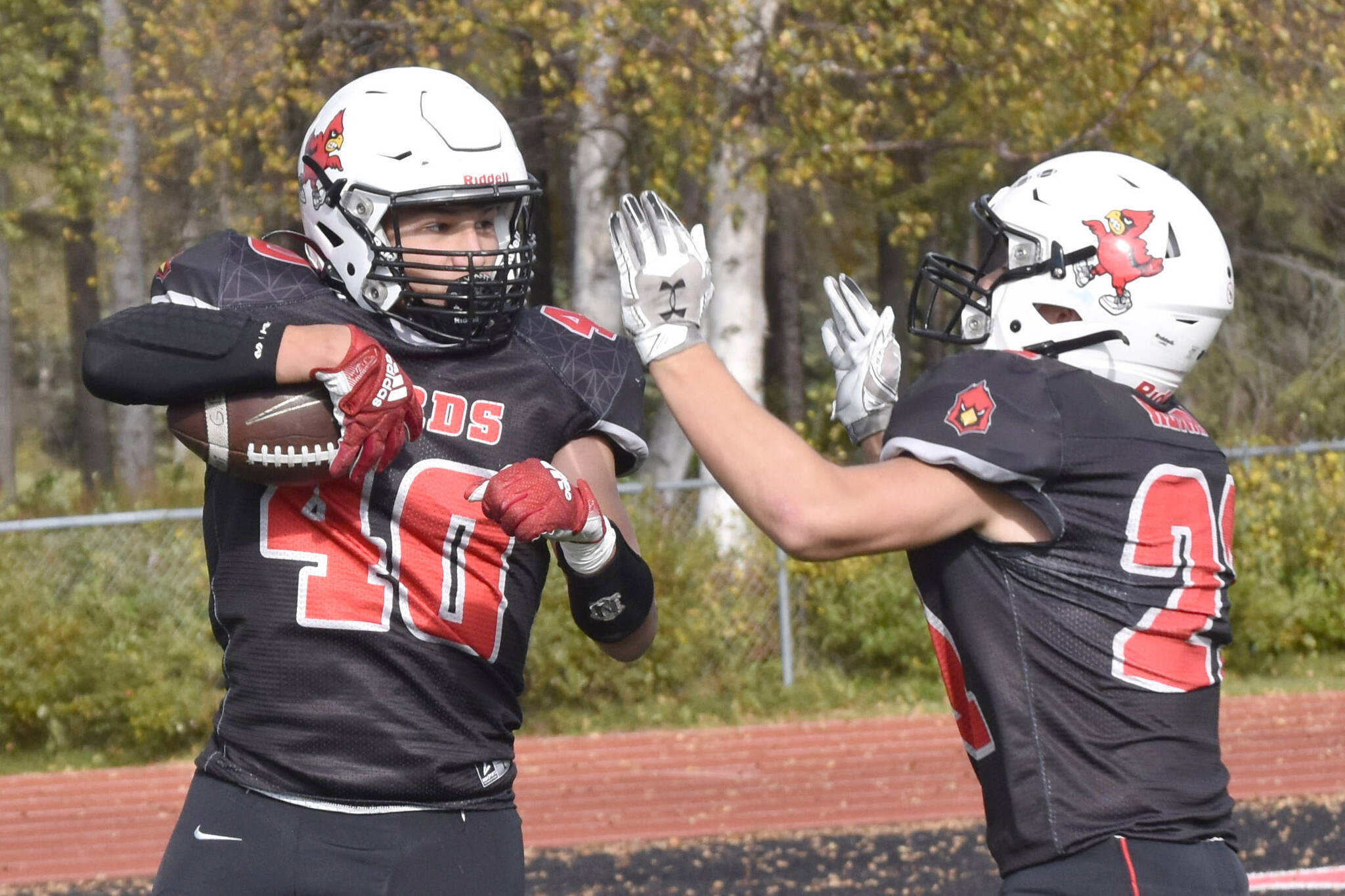 Kenai Central's Bobby Hayes celebrates his touchdown with William Wilson on Saturday, Sept. 23, 2023, at Ed Hollier Field at Kenai Central High School in Kenai, Alaska. (Photo by Jeff Helminiak/Peninsula Clarion)