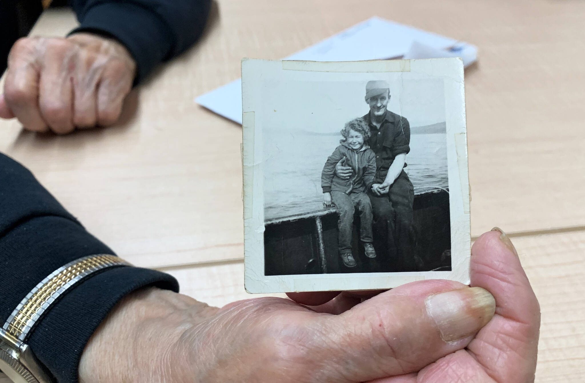 Mary Lou Bottorff, a survivor of Holy Cross Mission, holds a picture taken of her en route to Holy Cross Mission taken in Nome in 1948, when she was eight years old, inside the Tyotkas Elder Center on Wednesday, Oct. 4, 2023 in Kenai, Alaska. (Ashlyn O'Hara/Peninsula Clarion)