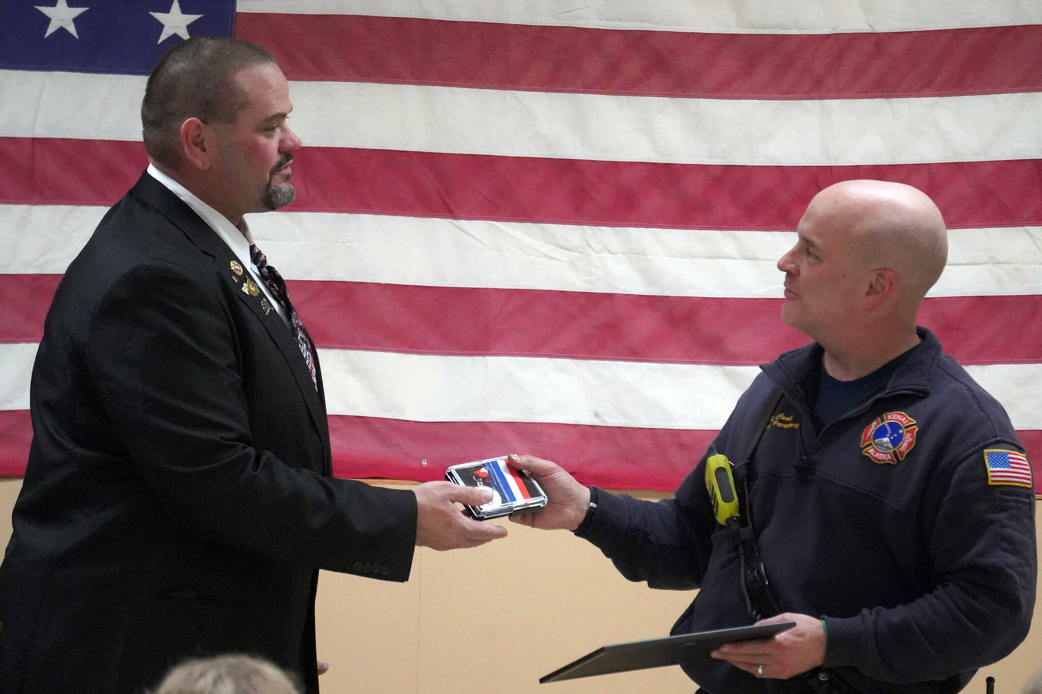 Kenai Elks Lodge Exalted Ruler Allen Burkett presents Kenai Fire Department’s Pete Coots with an award at the Kenai Elks Lodge in Kenai, Alaska, on Friday, Oct. 6, 2023. (Jake Dye/Peninsula Clarion)