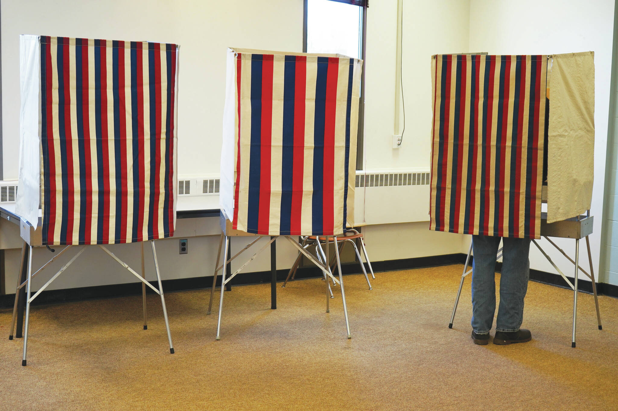 A lone voter fills in their ballot at Soldotna Prep School in Soldotna, Alaska, during Election Day on Tuesday, Oct. 3, 2023. (Jake Dye/Peninsula Clarion)