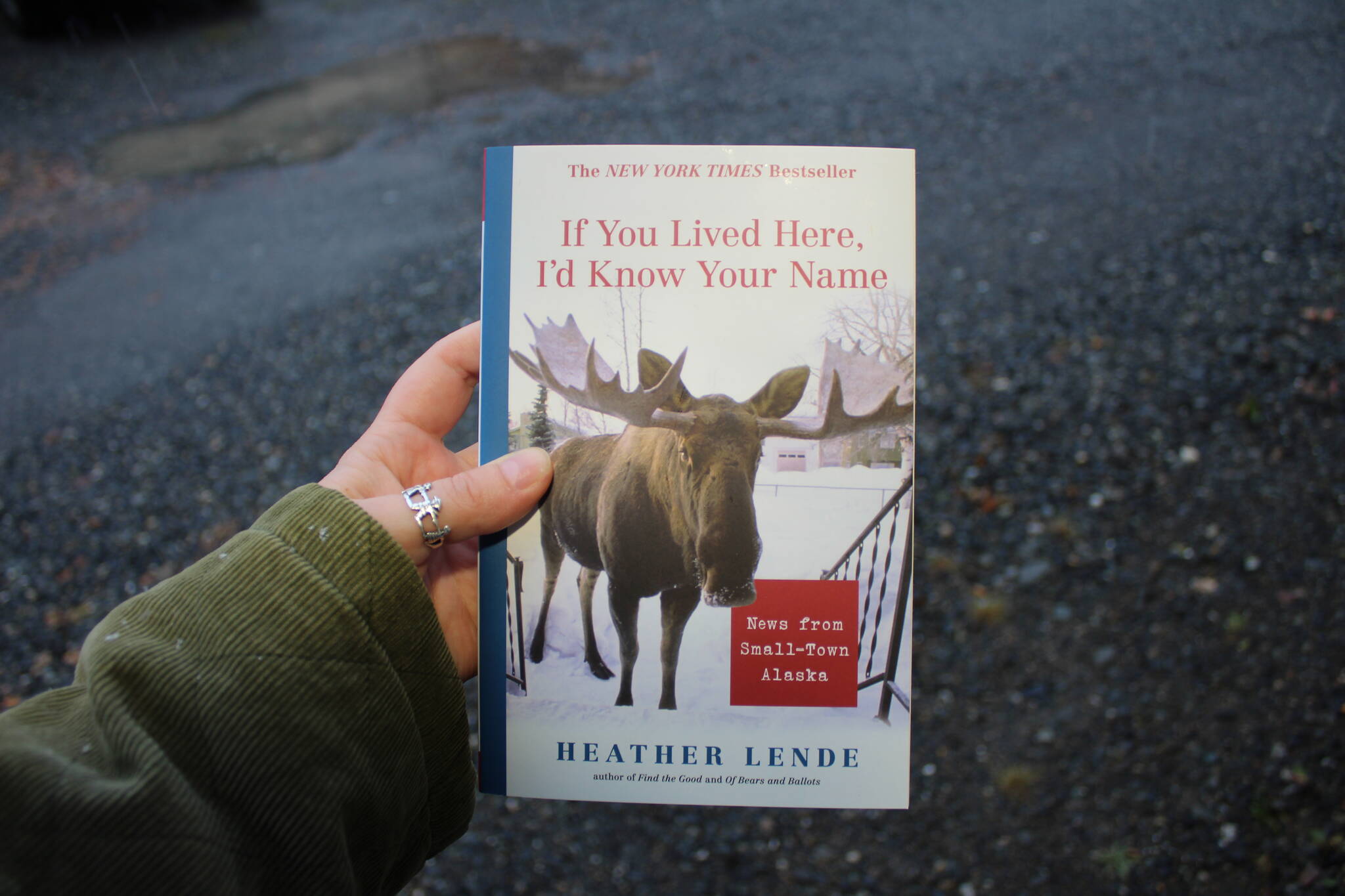 A copy of “If You Lived Here, I’d Know Your Name” is held on Thursday, Oct. 12, 2023, near Soldotna, Alaska. (Ashlyn O’Hara/Peninsula Clarion)
