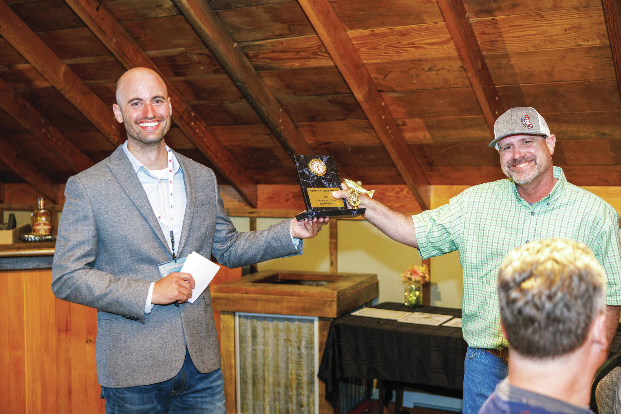 Photo courtesy Josiah Martin/Kenai Peninsula Food Bank
Jon Kruger hands an award for Trophy Catch of the Day to a participant of Catching for a Cause at the Cannery Lodge in Kenai.