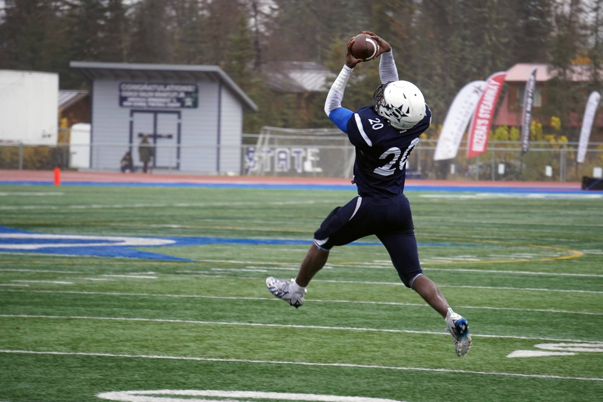 Soldotna’s Andon Wolverton leaps to catch the ball in the Division II semifinal against North Pole at Justin Maile Field in Soldotna, Alaska, on Saturday, Oct. 14, 2023. (Jake Dye/Peninsula Clarion)