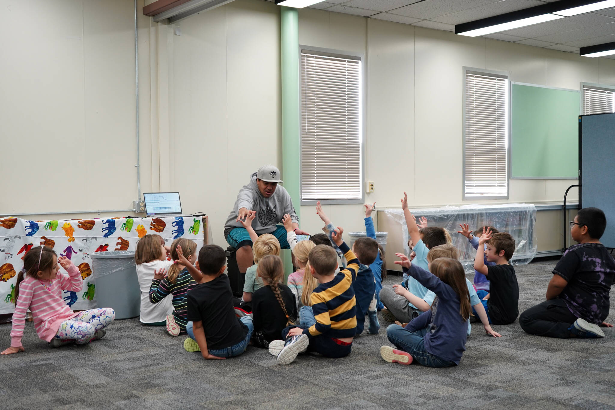 Jessie Soyangco, speaks to a class of kindergarteners at Kaleidoscope School of Arts and Science in Kenai, Alaska, on Thursday, Oct. 19, 2023. (Jake Dye/Peninsula Clarion)