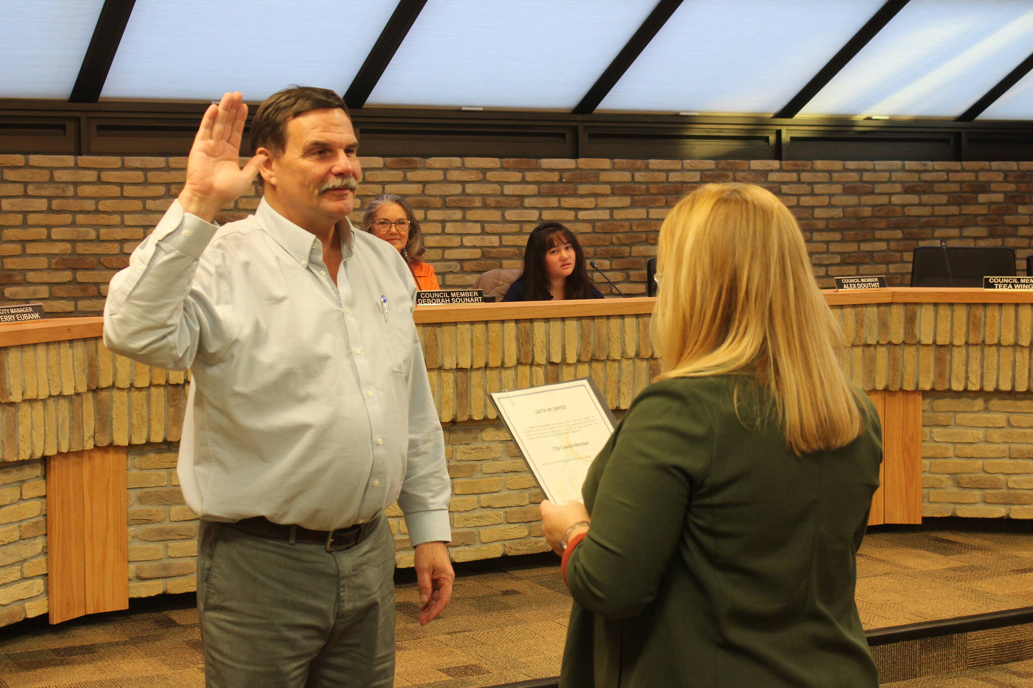 Kenai City Clerk Shellie Saner (right) administers an oath of office to Henry Knackstedt during a Kenai City Council meeting on Thursday, Oct. 19, 2023 in Kenai, Alaska. Knackstedt was elected to the council during the Oct. 3 election. (Ashlyn O’Hara/Peninsula Clarion)