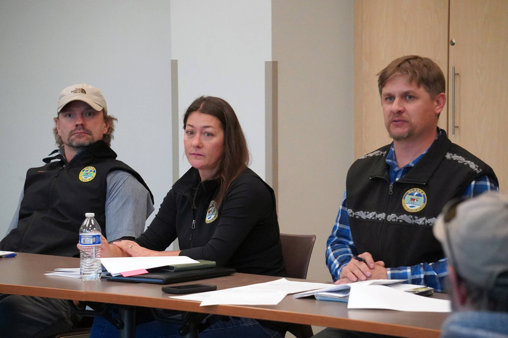 Tony Eskelin, Jenny Gates and Israel Payton listen to questions at a “Town Hall Style Meeting” held at Soldotna Public Library in Soldotna, Alaska, on Thursday, Oct. 26, 2023. (Jake Dye/Peninsula Clarion)
