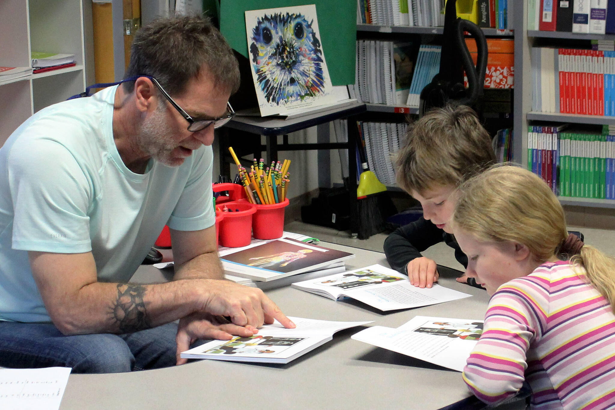 Hope School K-5 teacher Jeremy McKibben assists third grade students with reading skills part of CKLA’s “How Does Your Body Work?” unit on Wednesday, Oct. 18, 2023, in Hope, Alaska. (Ashlyn O’Hara/Peninsula Clarion)