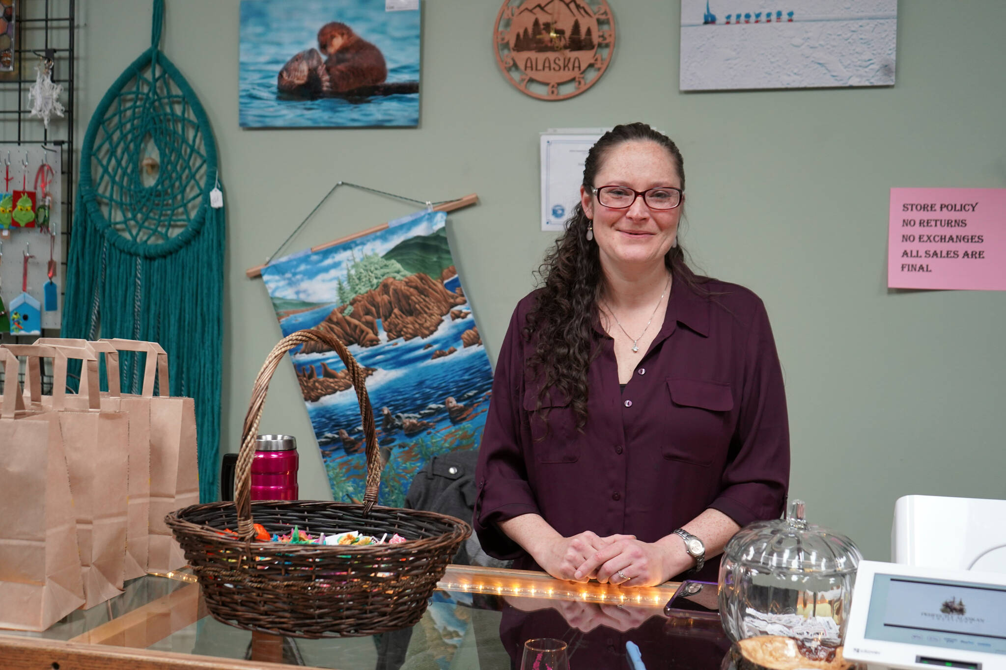 Jessica Dison stands at the counter of Perfectly Alaskan Creations in Kenai, Alaska, on Tuesday, Oct. 31, 2023. (Jake Dye/Peninsula Clarion)