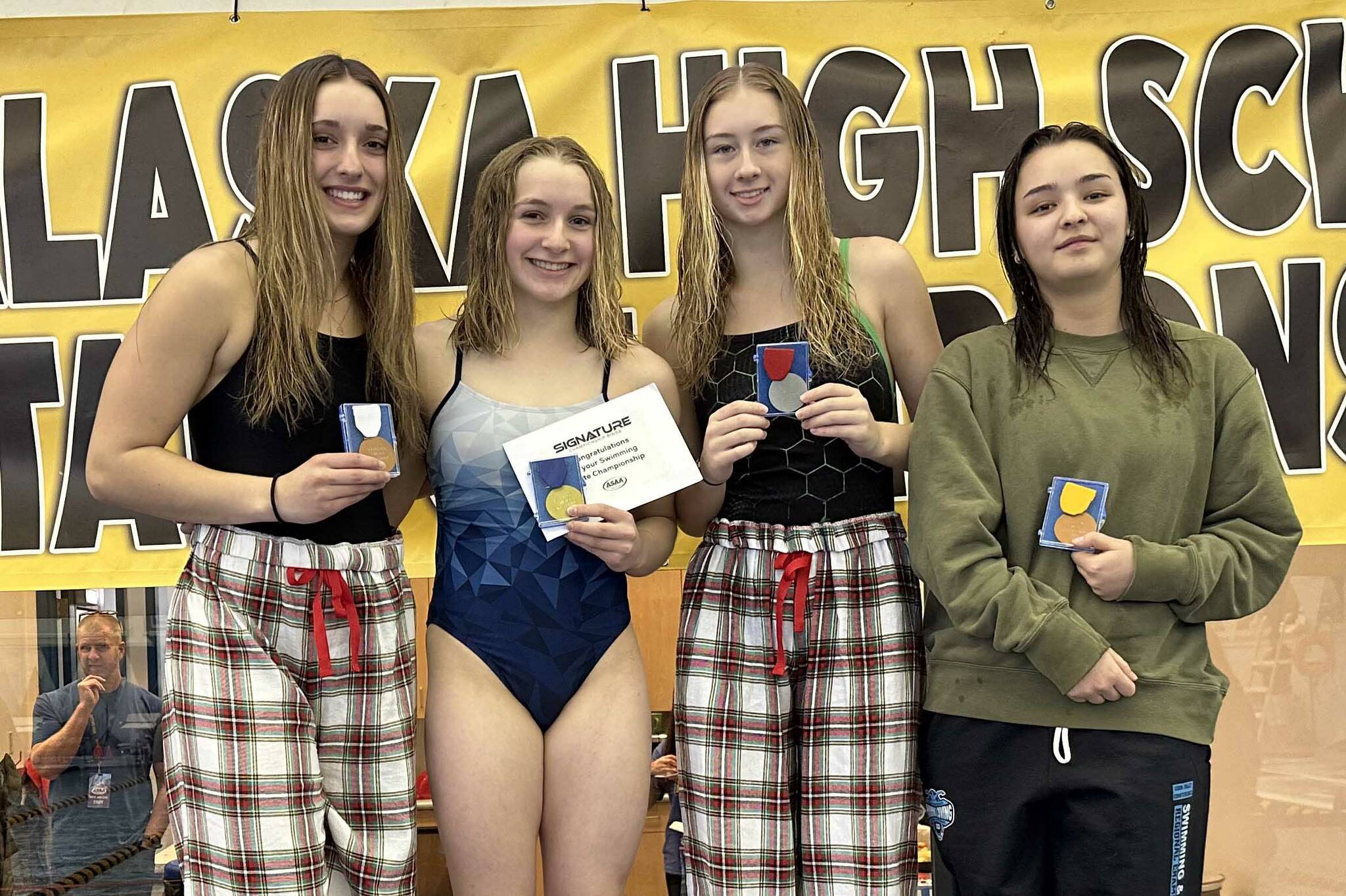 Colony's Claire Wallstrum, Soldotna's Abriella Werner, Colony's Charlie McManus and Service's Faith Colman on the diving podium at the state swimming and diving meet in Juneau, Alaska, on Saturday, Nov. 4, 2023. Werner won the state title. (Photo provided)