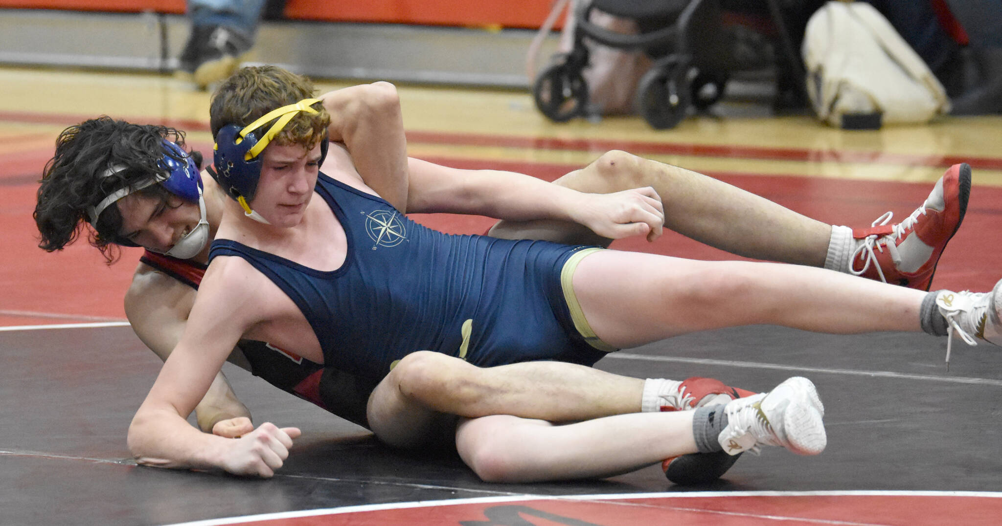 Kenai Central’s Atlas Ruark wrestles Homer’s Alexander Van Meter at 160 pounds during a dual meet Tuesday, Nov. 7, 2023, at Kenai Central High School in Kenai, Alaska. (Photo by Jeff Helminiak/Peninsula Clarion)