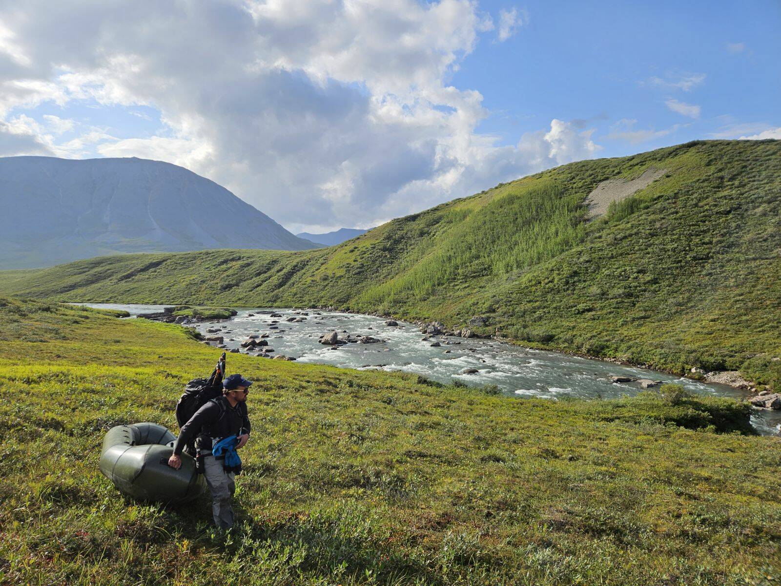 Ben Meyer carries his raft during a pack-rafting trip in the Brooks Range in August 2023. (Photo courtesy Ben Meyer)