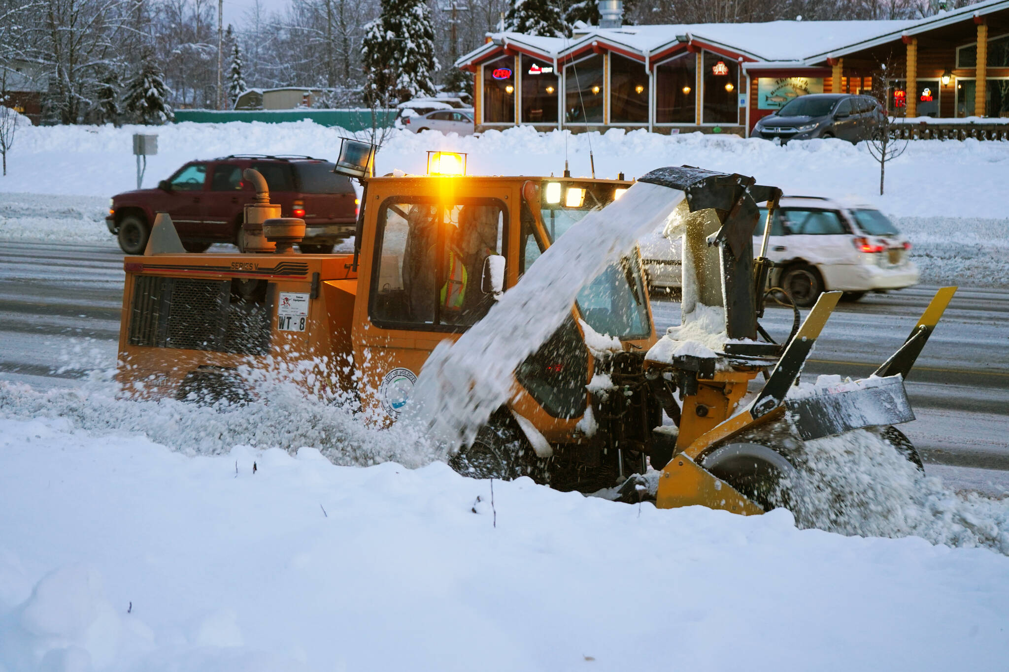 Snow is cleared from a sidewalk along the Sterling Highway in Soldotna, Alaska, on Thursday, Nov. 9, 2023. (Jake Dye/Peninsula Clarion)