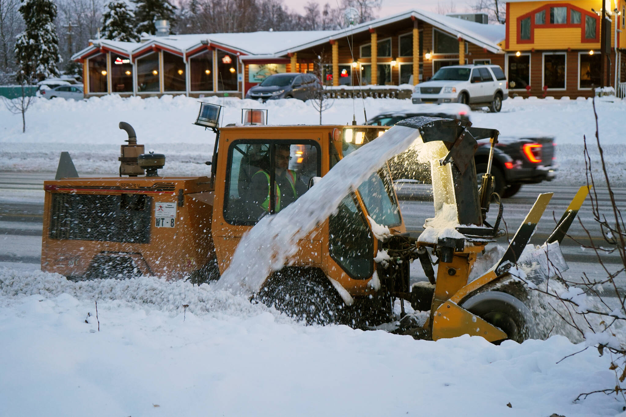 Snow is cleared from a sidewalk along the Sterling Highway in Soldotna, Alaska, on Thursday, Nov. 9, 2023. (Jake Dye/Peninsula Clarion)