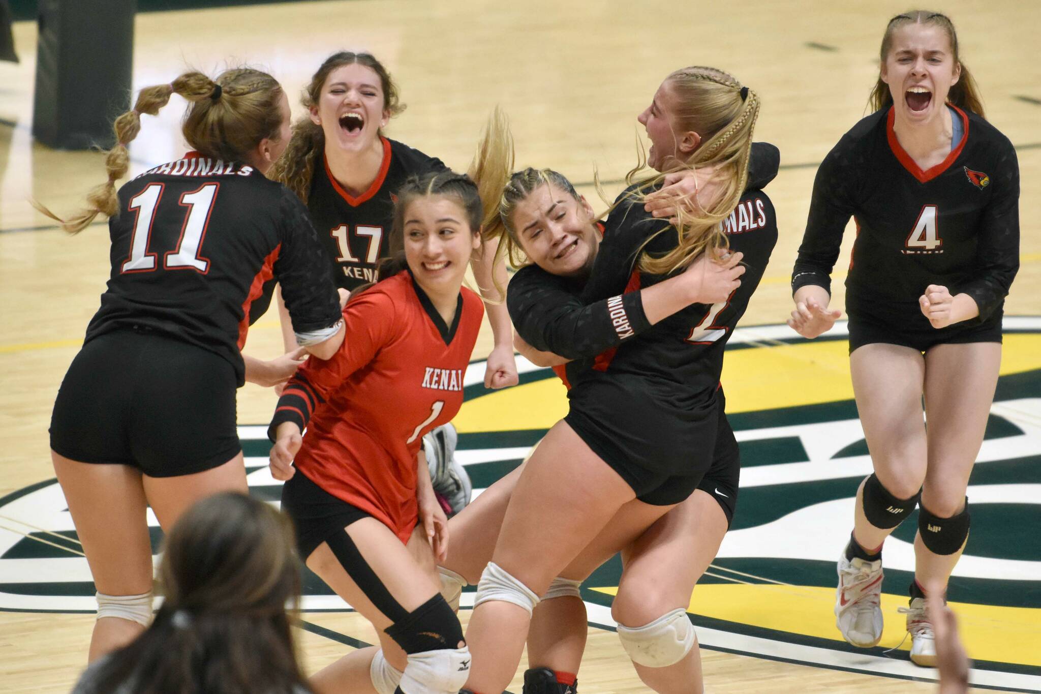 The Kenai Central volleyball team celebrates defeating Valdez for the Class 3A state title Saturday, Nov. 11, 2023, at the Alaska Airlines Center in Anchorage, Alaska. (Photo by Jeff Helminiak/Peninsula Clarion)