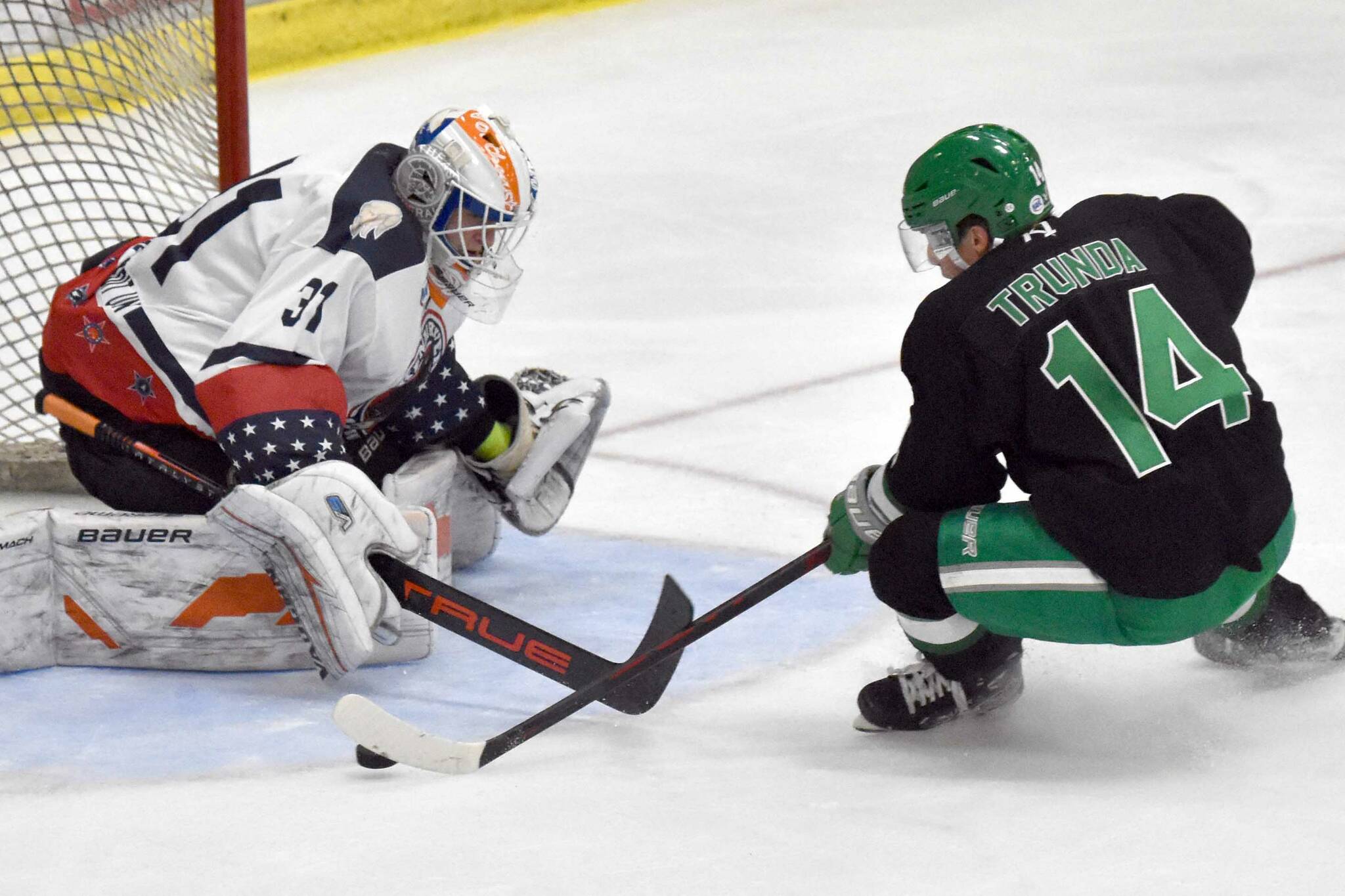 Kenai River goaltender Marks Slavinskis-Repe saves a breakaway attempt by Tomas Trunda of the Chippewa (Wisconsin) Steel on Sunday, Nov. 12, 2023, at the Soldotna Regional Sports Complex in Soldotna, Alaska. (Photo by Jeff Helminiak/Peninsula Clarion)