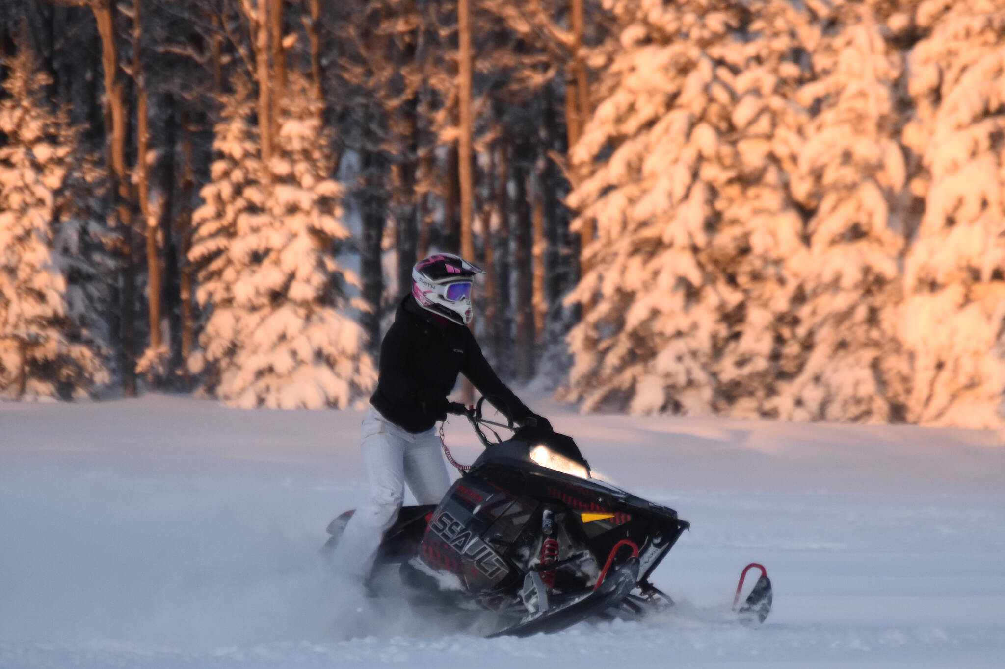 A snowmachine rider takes advantage of two feet of fresh snow on a field down Murwood Avenue in Soldotna, Alaska on Monday, Dec. 12, 2022. (Jake Dye/Peninsula Clarion)