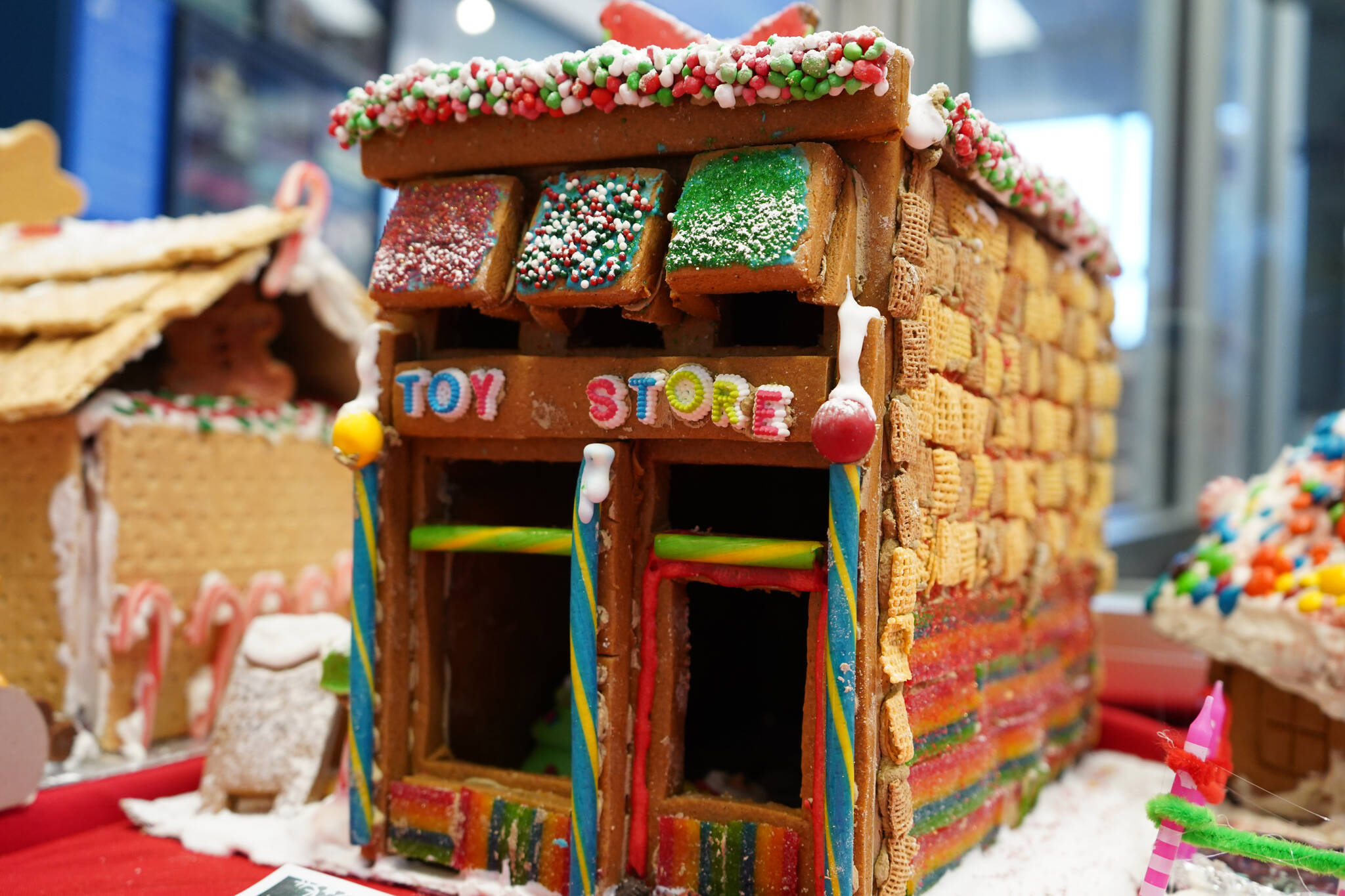 A gingerbread toy store constructed by 5-year-old Easton is displayed as part of the 11th Annual Gingerbread House Contest at the Kenai Chamber of Commerce and Visitor Center in Kenai, Alaska, on Thursday, Nov. 16, 2023. (Jake Dye/Peninsula Clarion)