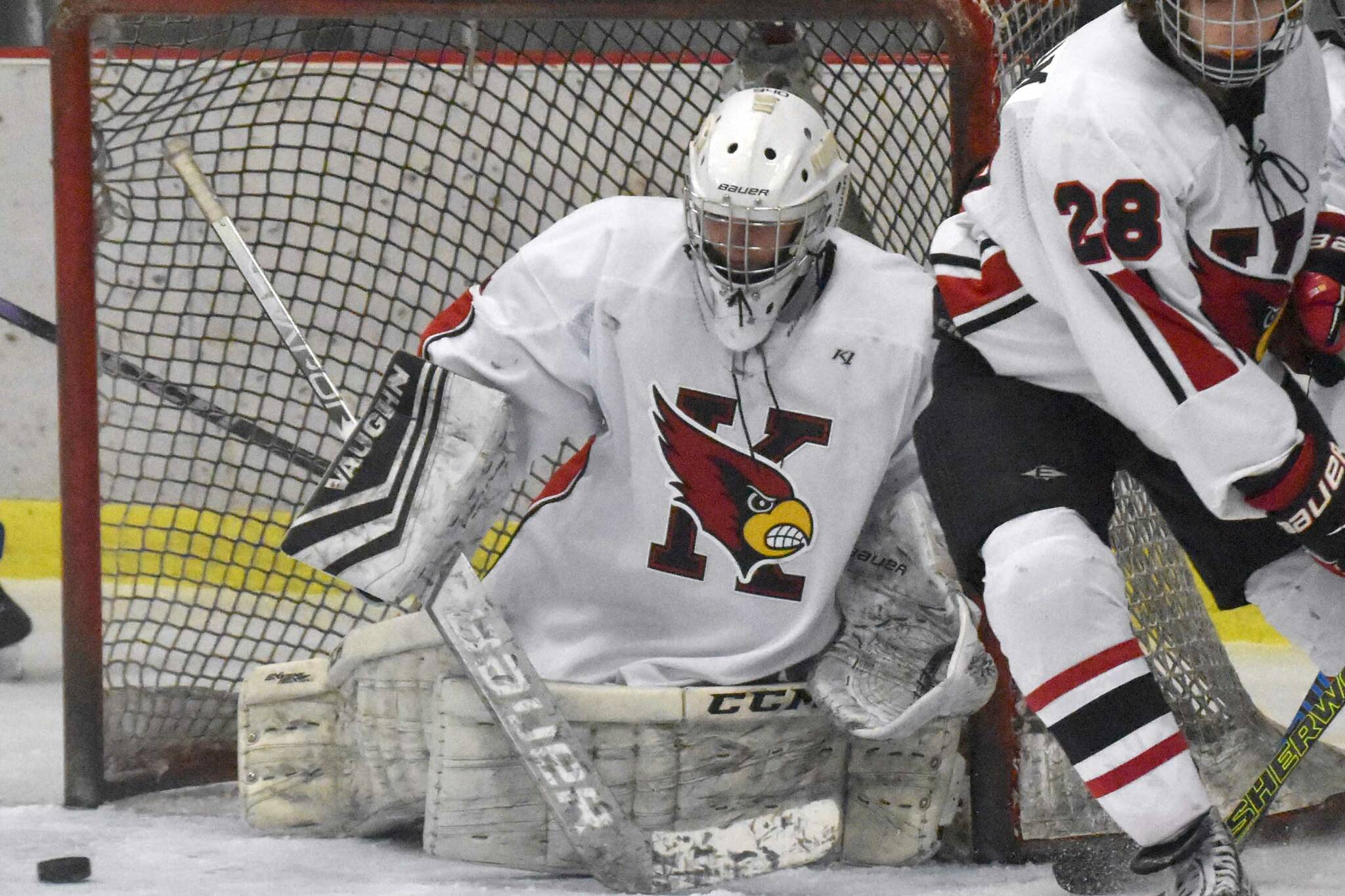 Kenai Central's Seanna Swanson scrambles to make a save while Cole Langham and Kylee Verkuilen hold off Palmer's Elijah Von Gunten on Thursday, Nov. 16, 2023, during Kenai River Cup play at the Kenai Multi-Purpose Facility in Kenai, Alaska. (Photo by Jeff Helminiak/Peninsula Clarion)