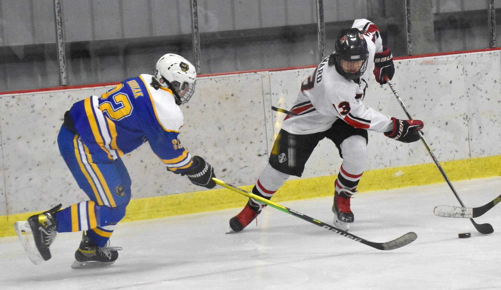 Kenai Central’s Will Howard attacks against Kodiak’s Theron Glover on Saturday, Nov. 18, 2023, at the Kenai Multi-Purpose Facility in Kenai, Alaska. (Photo by Jeff Helminiak/Peninsula Clarion)
