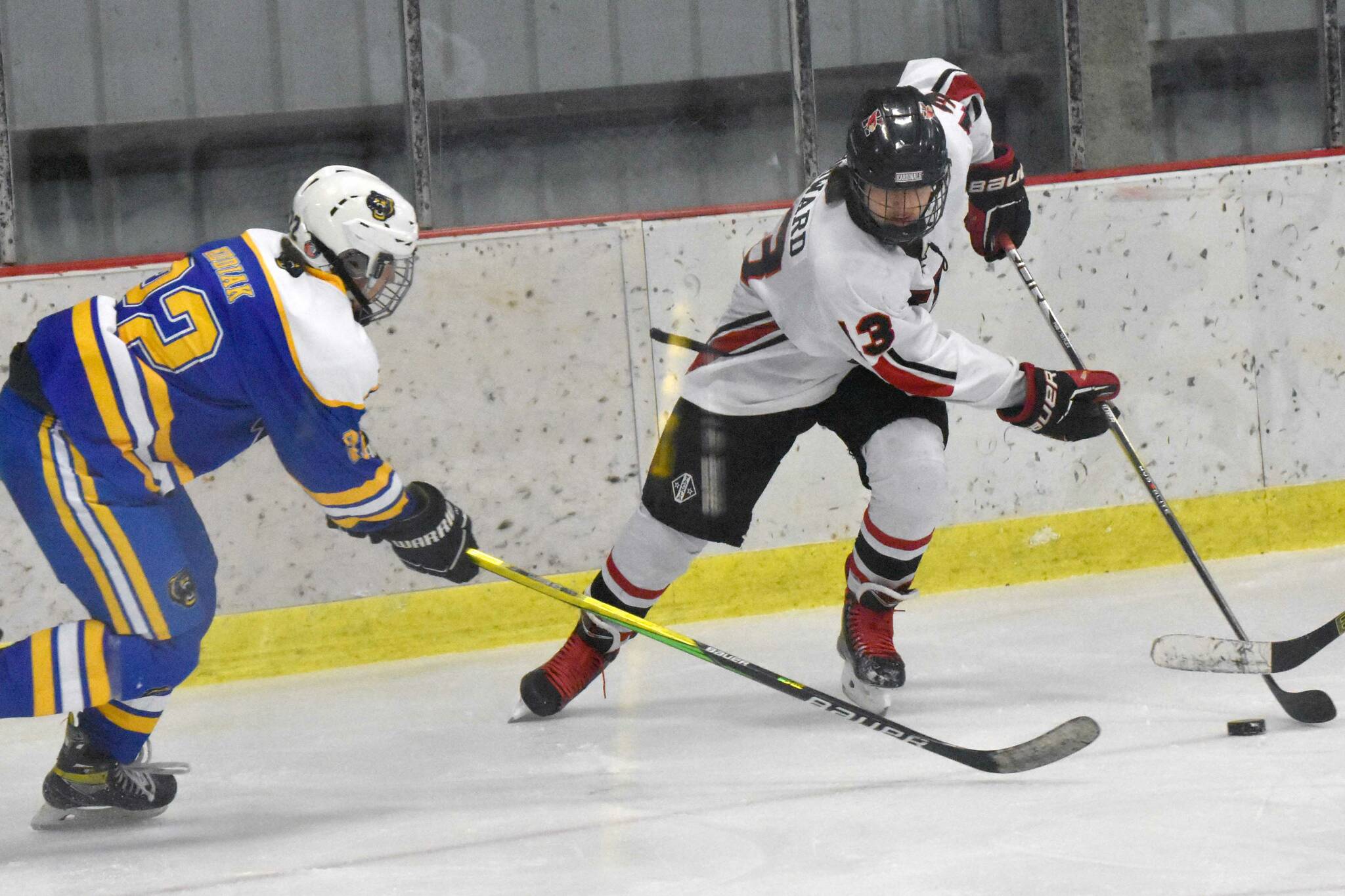 Kenai Central's Will Howard attacks against Kodiak's Theron Glover on Saturday, Nov. 18, 2023, at the Kenai Multi-Purpose Facility in Kenai, Alaska. (Photo by Jeff Helminiak/Peninsula Clarion)