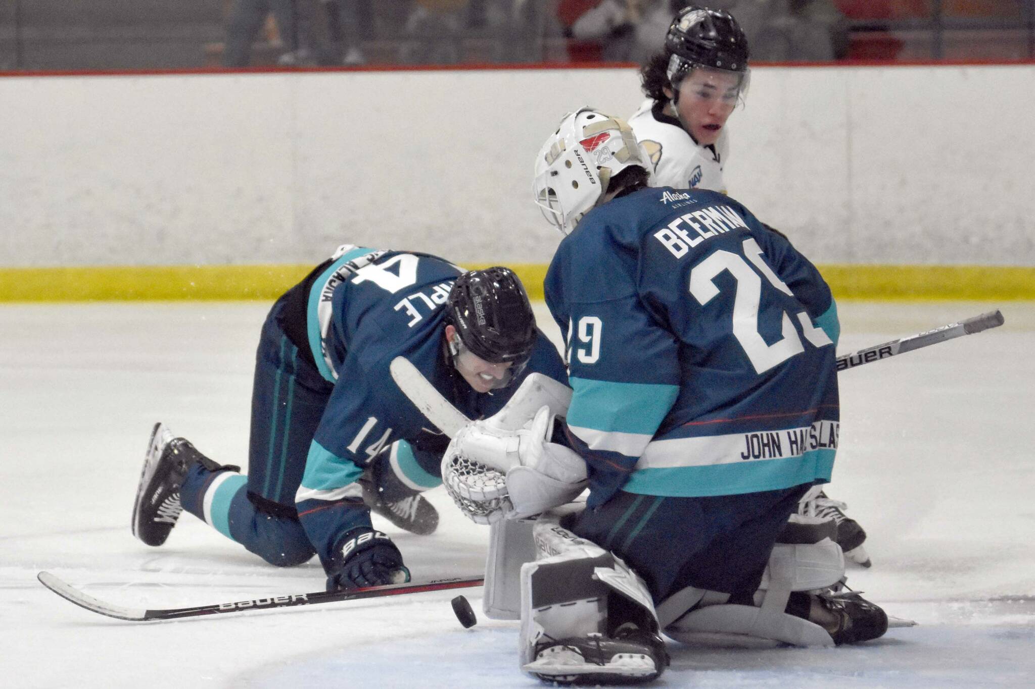 Kenai River's Dylan Contreras drives the net against Anchorage Wolverines' Jackson Stimple and Liam Beerman on Saturday, Nov. 18, 2023, at the Soldotna Regional Sports Complex in Soldotna, Alaska. (Photo by Jeff Helminiak/Peninsula Clarion)