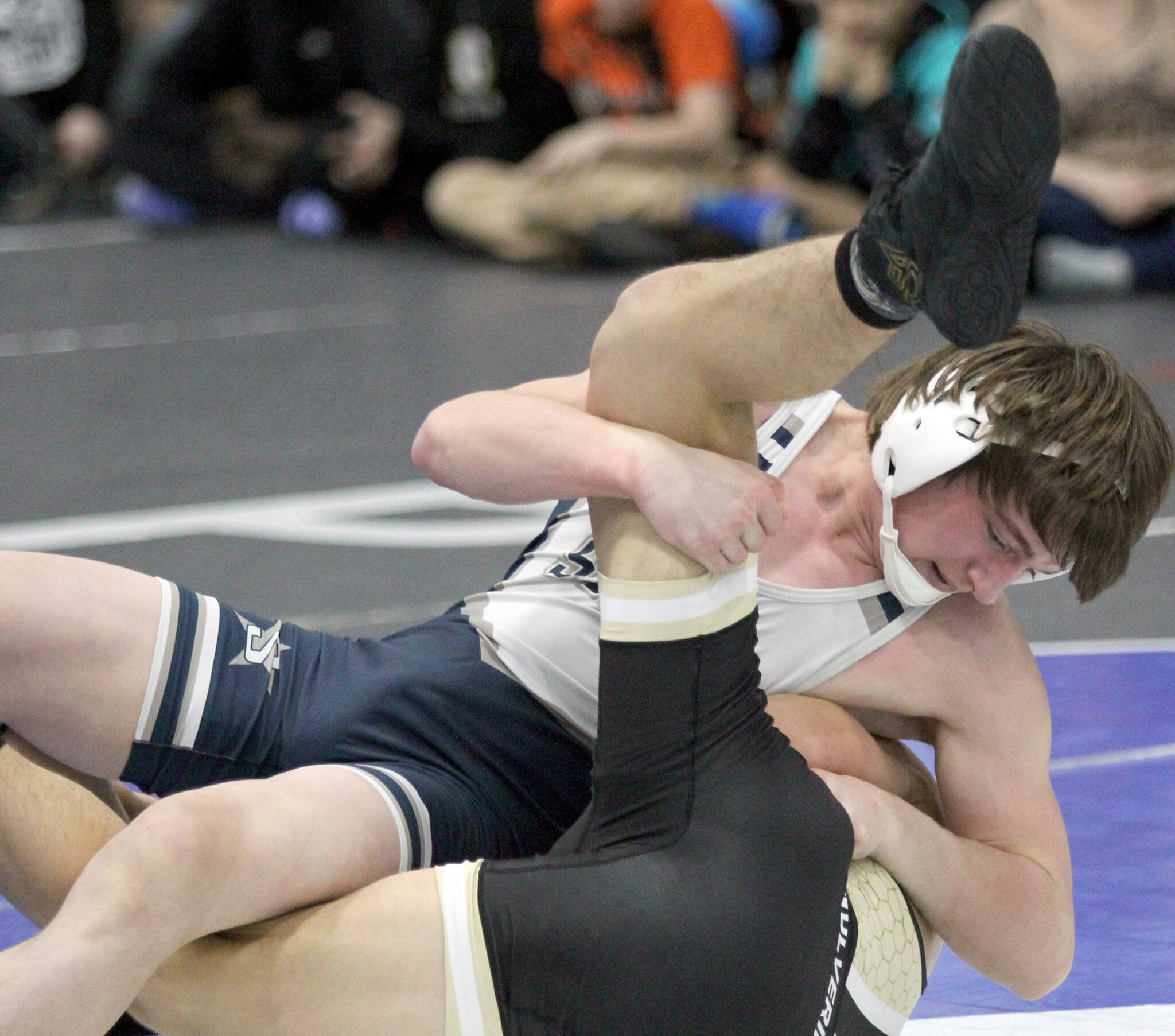 Soldotna junior Hunter Bras tries to score early points during a sudden victory win over South Anchorage’s Clayton McGuire in the 145-pound final of the Lancer Smith Memorial on Saturday, Nov. 18, 2023, at the Menard Arena in Wasilla, Alaska. (Photo by Jeremiah Bartz/Frontiersman)