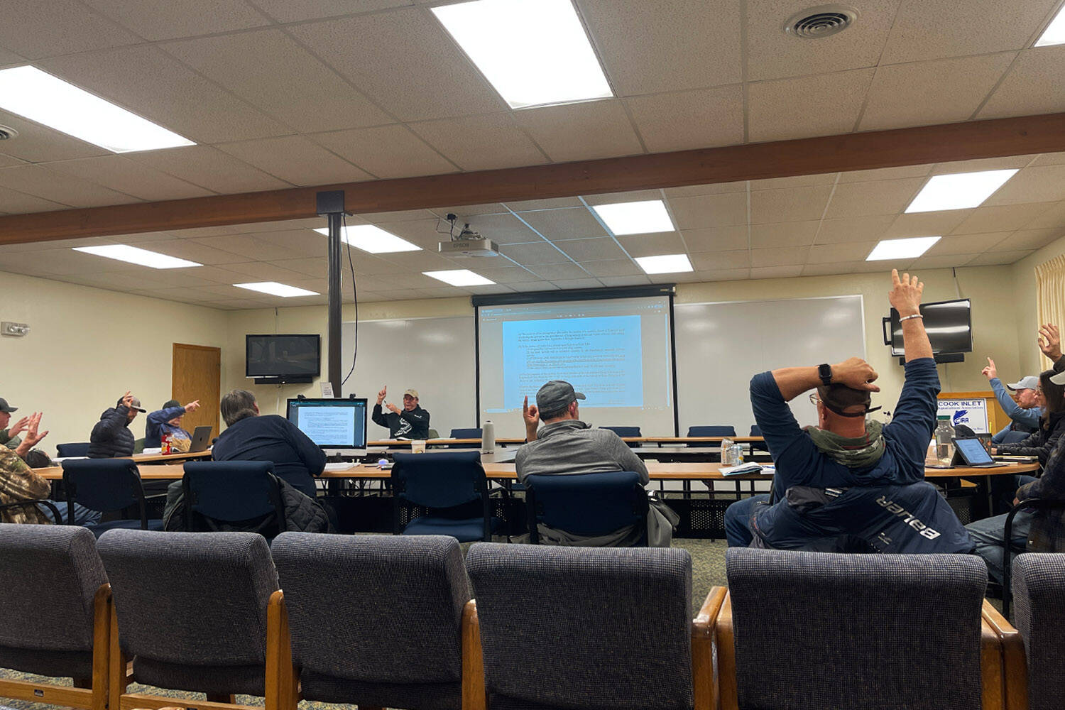 Members of the Kenai/Soldotna Fish and Game Advisory Committee raise hands to vote in favor of a proposal during a meeting at Cook Inlet Aquaculture Association in Kenai, Alaska, on Monday, Nov. 20, 2023. (Jake Dye/Peninsula Clarion)