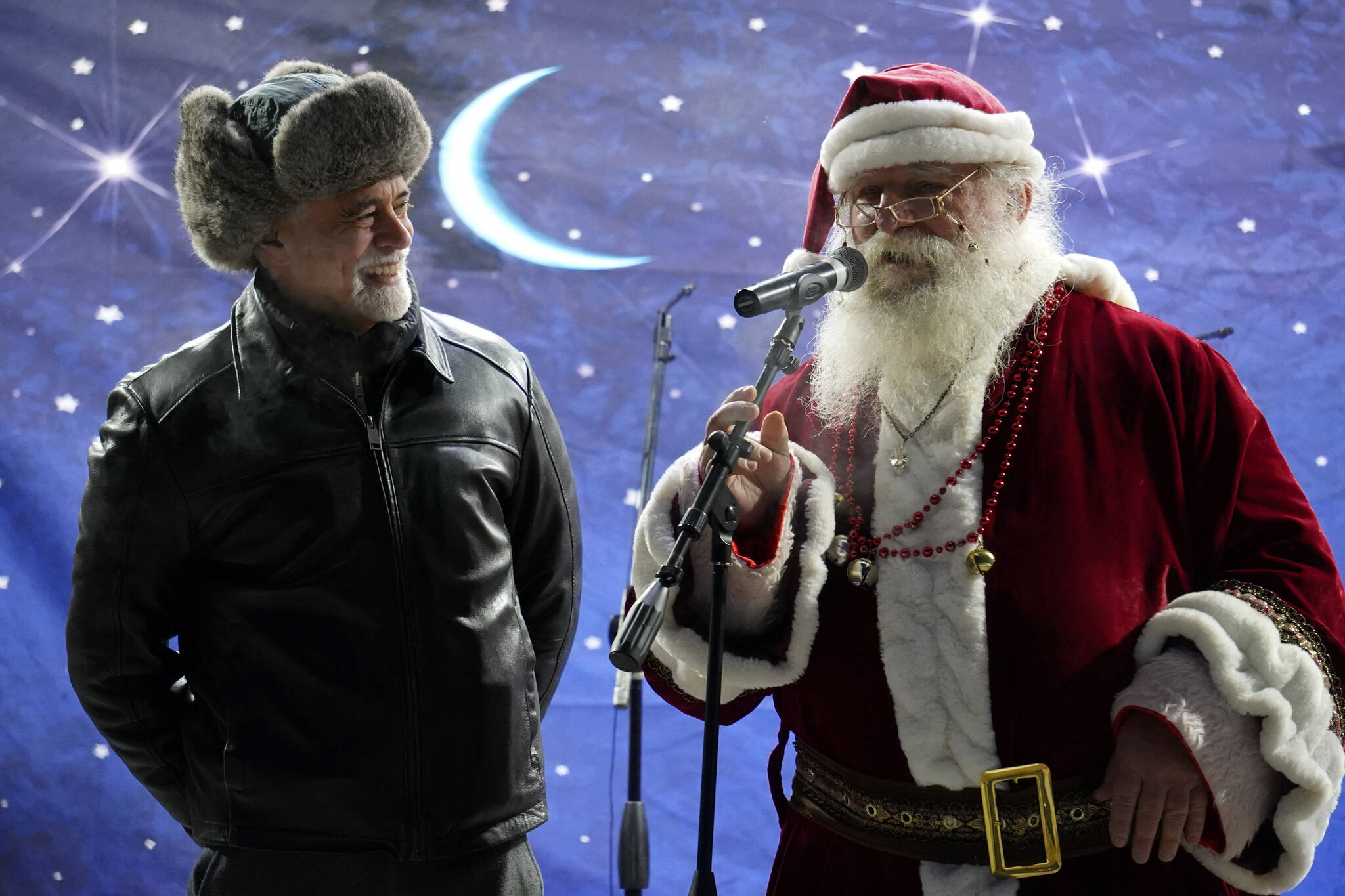 Kenai Peninsula Borough Mayor Peter Micciche and Santa Claus speak to attendees of Christmas in the Park at Soldotna Creek Park in Soldotna, Alaska, on Saturday, Dec. 2, 2023. (Jake Dye/Peninsula Clarion)