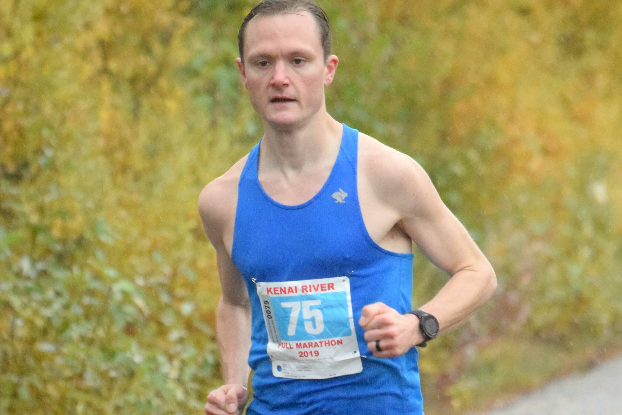 Kenai's Jason Parks, running on Kalifornsky Beach Road in Kenai, Alaska, wins the Kenai River Marathon on Sept. 28, 2019. (Photo by Jeff Helminiak/Peninsula Clarion)