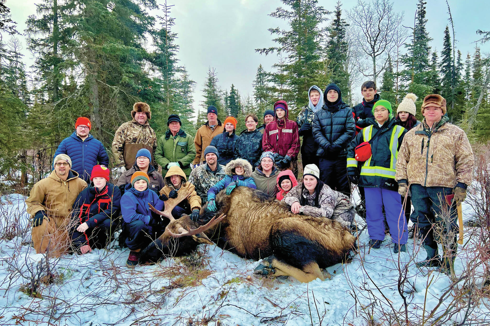 Students from Nikiski Middle/High School and Kenai Middle School join Jesse Bjorkman, Ken Felchle and volunteers from the Kenai Peninsula Chapter of Safari Club International on an educational moose hunt in Nikiski, Alaska, on Saturday, Dec. 2, 2023. (Photo provided by Jesse Bjorkman)