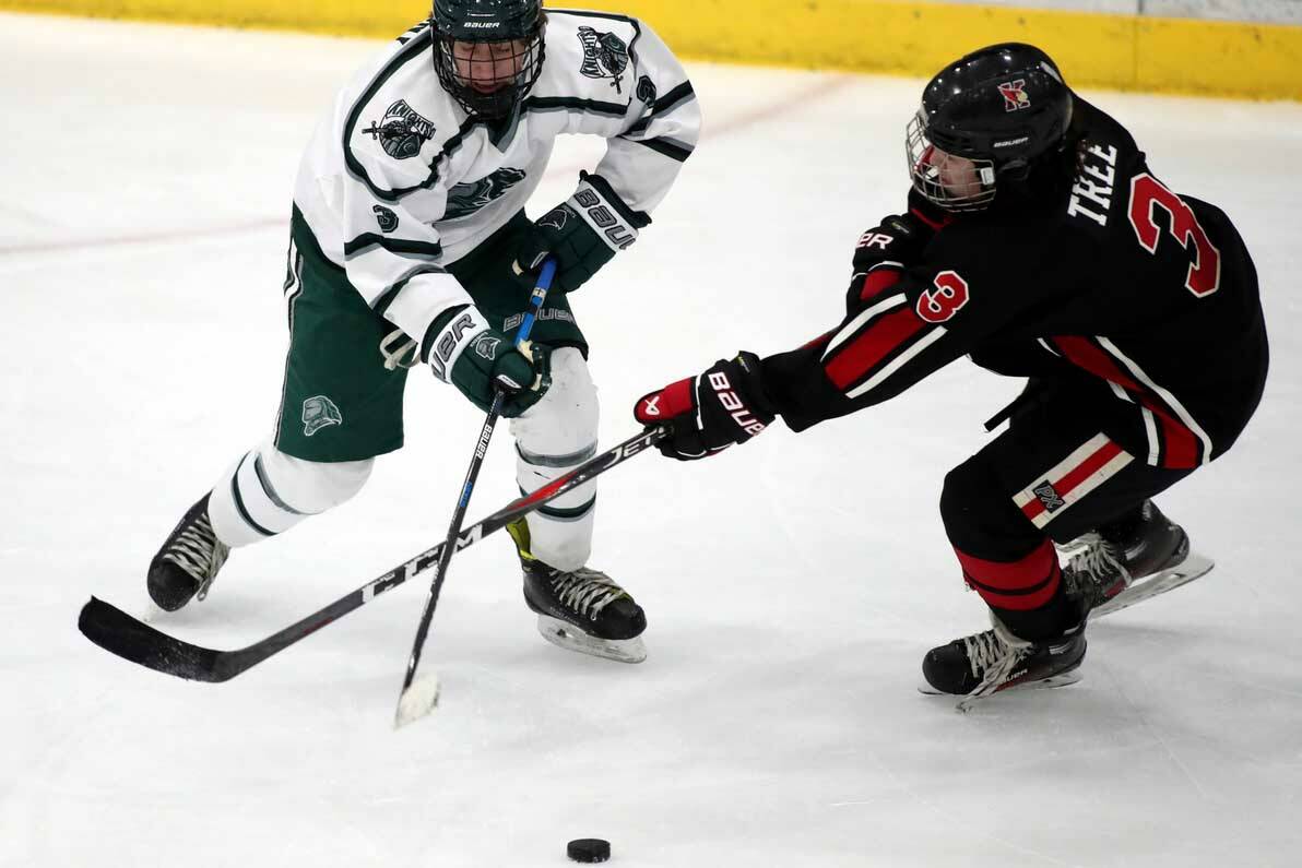 Kenais’ Ethan tree tries to poke the puck away from Colony’s Boston Weiland during a 6-6 tie Friday, Dec. 8, 2023, at the Menard Arena in Wasilla, Alaska. (Photo by Bruce Eggleston/matsusports.net)