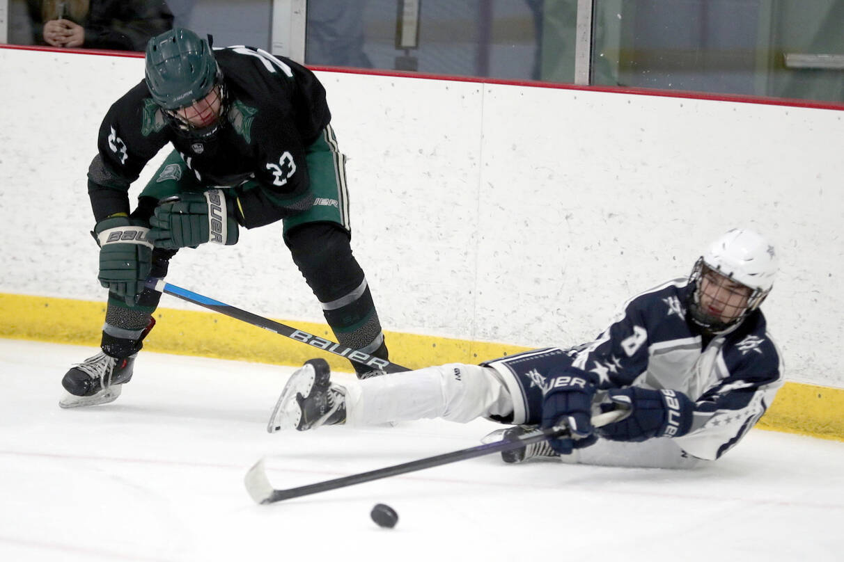 Soldotna’s Riley Cronin tries to keep the puck aweay from Colony’s Allen Baldwin after falling to the ice during a 4-3 loss to the Knights on Saturday, Dec. 8, 2023, at the Menard Arena in Wasilla, Alaska. (Photo by Bruce Eggleston/matsusports.net)