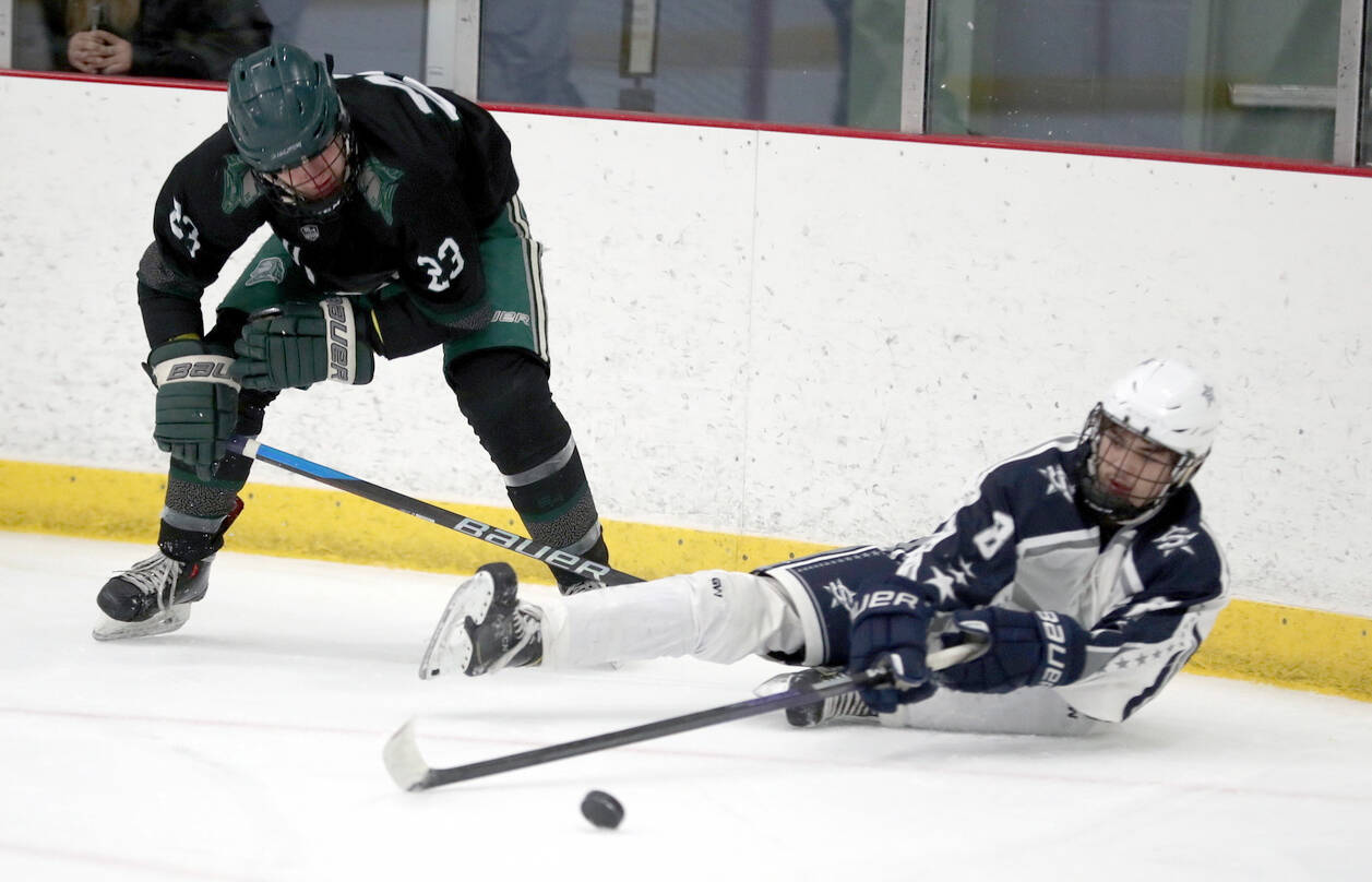 Soldotna’s Riley Cronin tries to keep the puck aweay from Colony’s Allen Baldwin after falling to the ice during a 4-3 loss to the Knights on Saturday, Dec. 8, 2023, at the Menard Arena in Wasilla, Alaska. (Photo by Bruce Eggleston/matsusports.net)