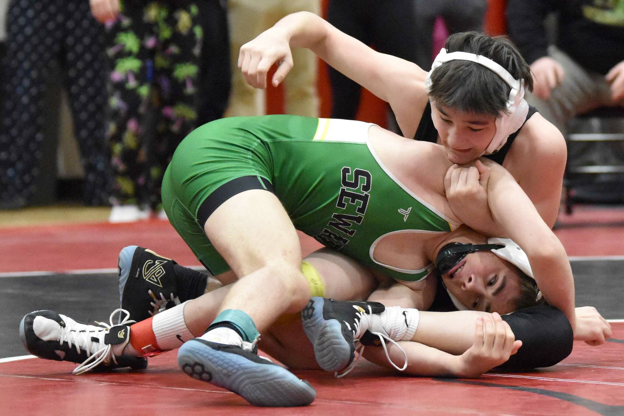 Seward's Aidan Schilling and Kenai Central's Jaxson Young wrestle in the championship at 119 pounds at the Kachemak Conference wrestling tournament at Kenai Central High School in Kenai, Alaska, on Saturday, Dec. 9, 2023. Schilling took a 7-5 decision. (Photo by Jeff Helminiak/Peninsula Clarion)