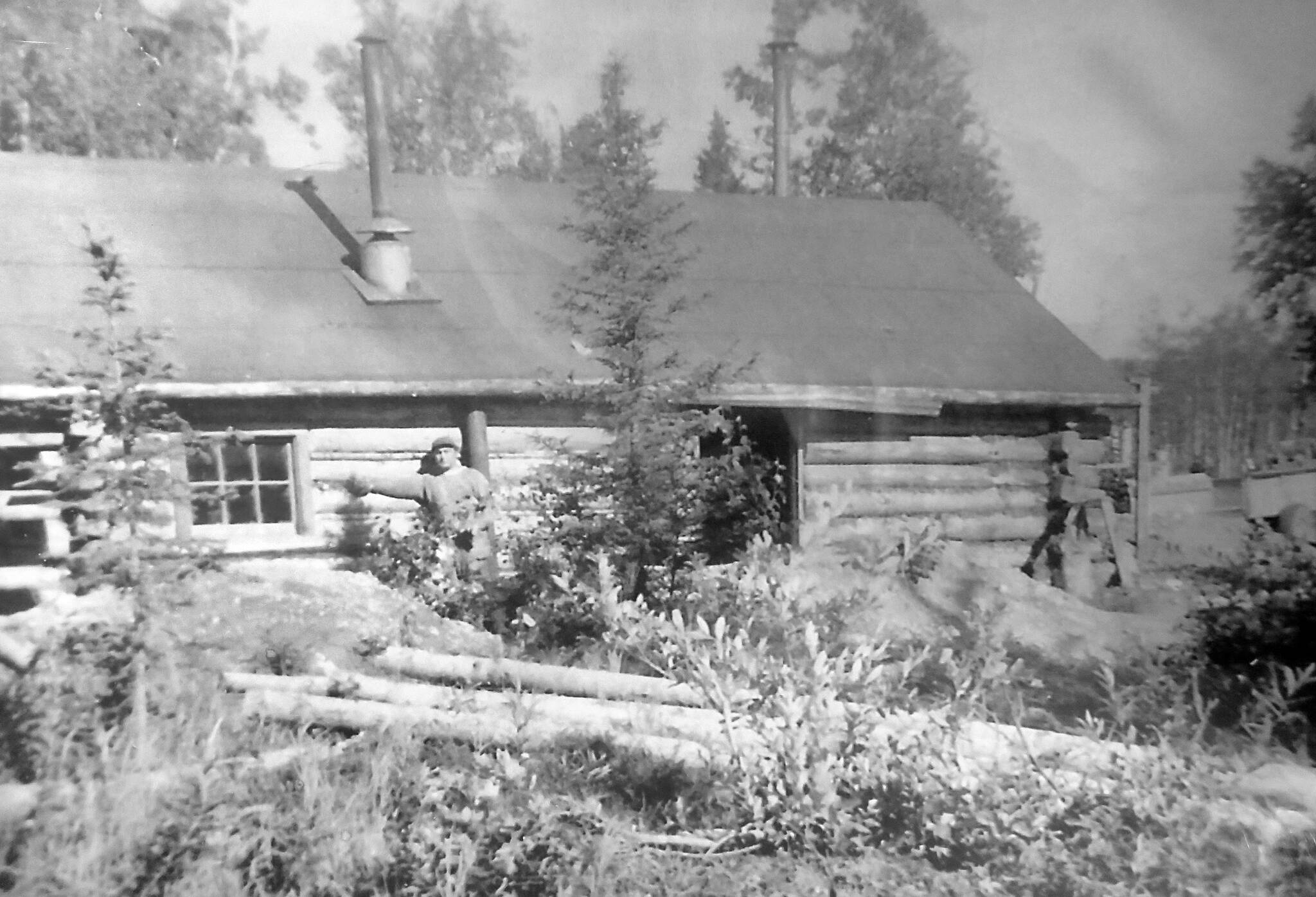 In about 1948, after he and brother Alex had proven up on his homestead and were in the process of proving up on Alex’s, Marcus Bodnar poses here with his cabin along the Kenai River near the site of the bridge, which was just being built at this time. (Photo courtesy of the Bodnar Family Collection)