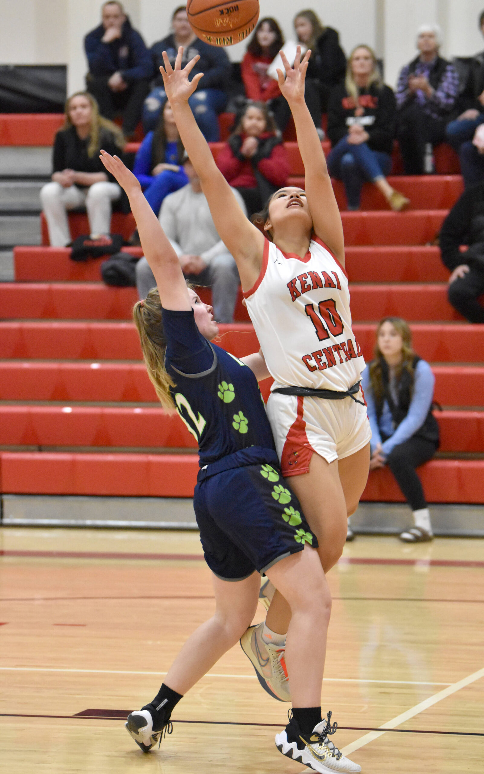 Kenai Central’s Alex Nelson goes up for a shot against Redington’s Sonia Gericke on Thursday, Dec. 14, 2023, at the Craig Jung Tournament at Kenai Central High School in Kenai, Alaska. (Photo by Jeff Helminiak/Peninsula Clarion)