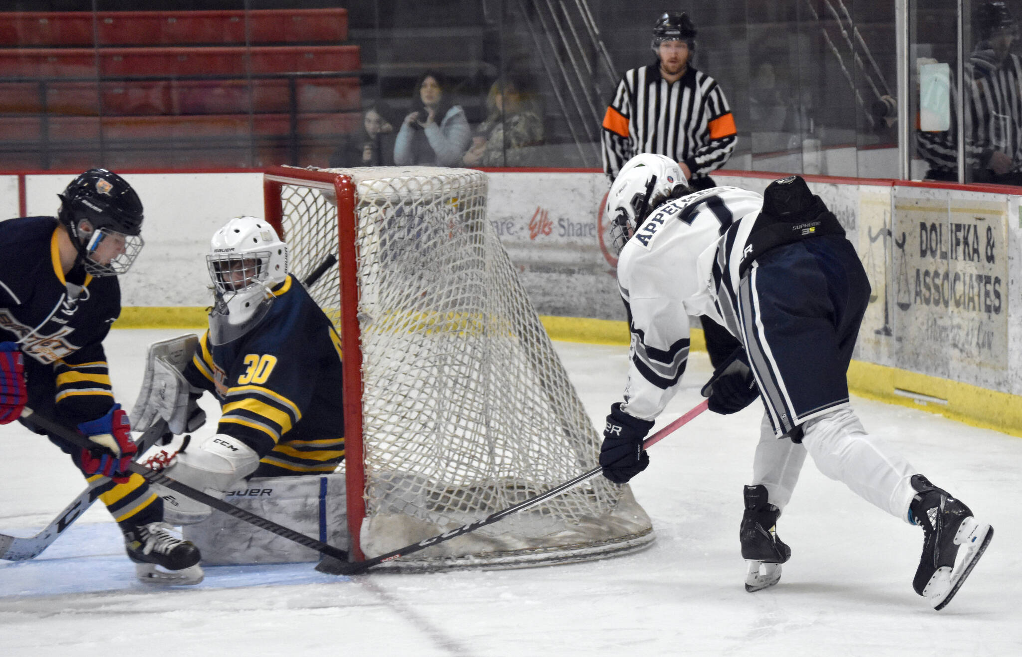 Soldotnas Jace Appelhans stuffs in a goal past Bartlett-East co-op goalie Reece Morton and defender Edwin Maxwell on Friday, Dec. 15, 2023, at the Soldotna Regional Sports Complex in Soldotna, Alaska. (Photo by Jeff Helminiak/Peninsula Clarion)