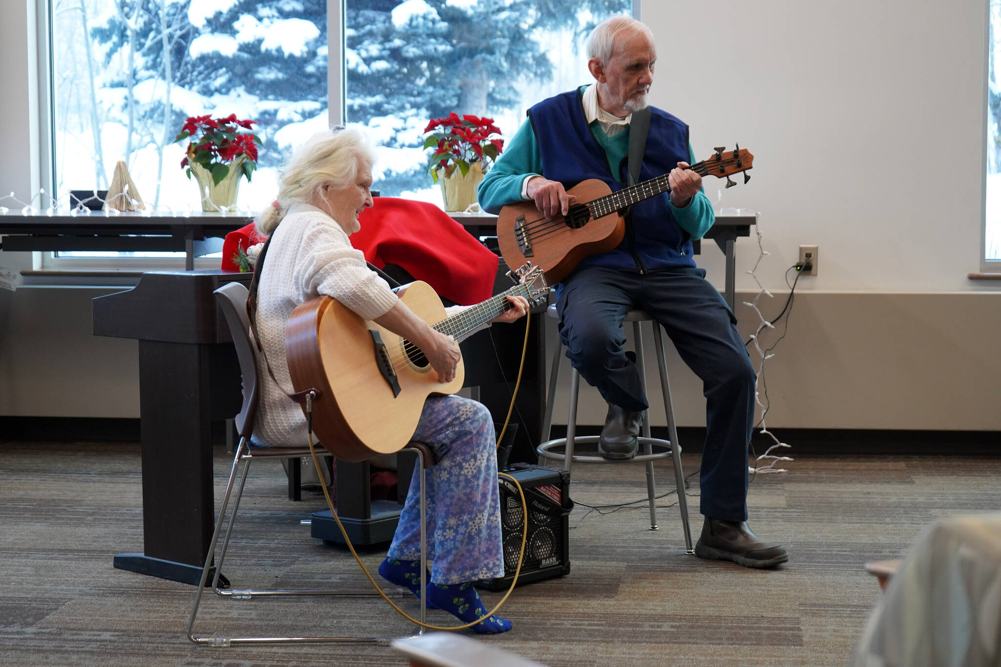 Elena Corey and Jim Pate perform during Music by the Fire at the Soldotna Public Library in Soldotna, Alaska, on Thursday, Dec. 21, 2023. (Jake Dye/Peninsula Clarion)