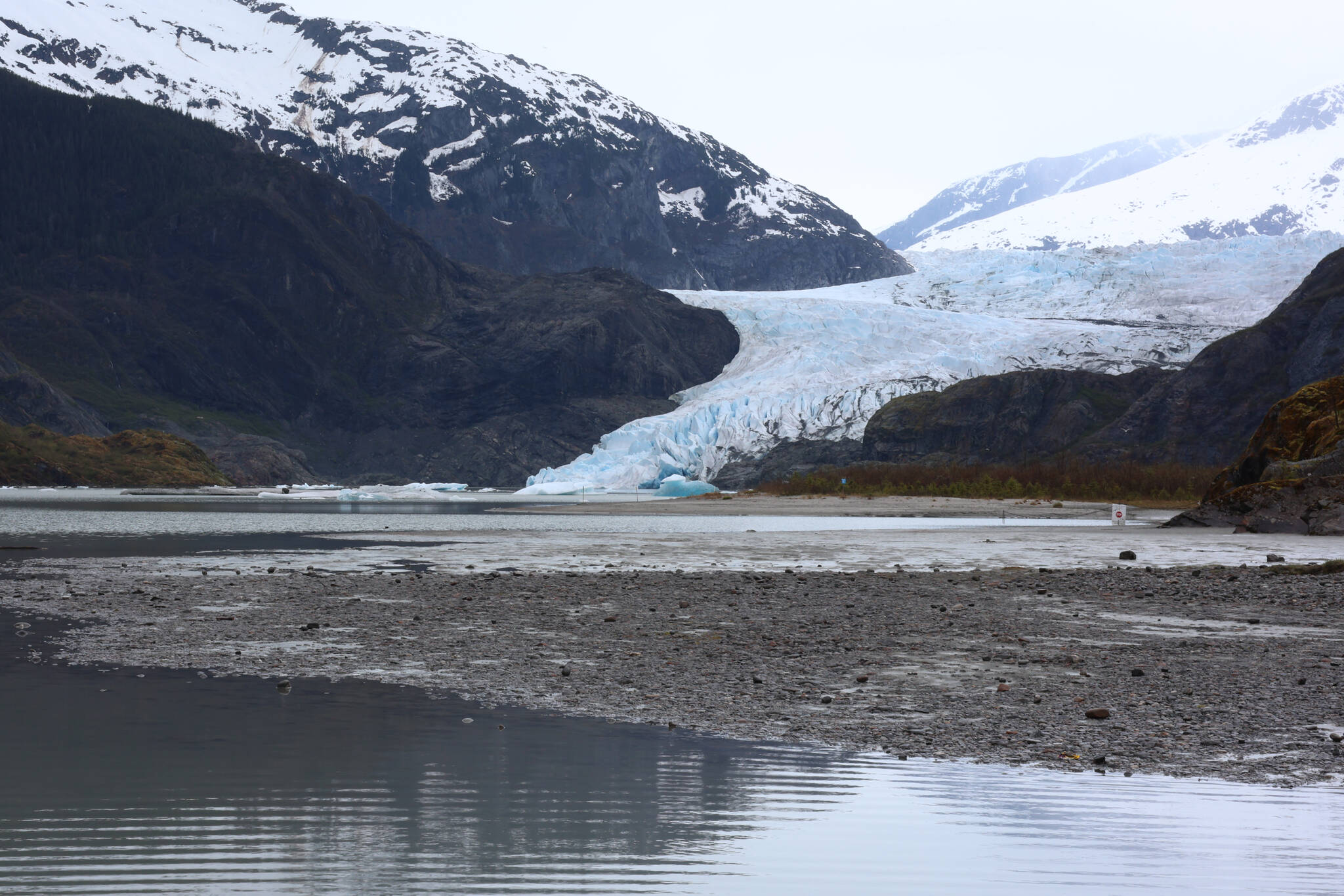 The Mendenhall Glacier and surrounding area is seen under an overcast sky on May 12, 2023. A federal order bans mineral extraction activities such as mining in an expanded area of land surrounding the glacier for the next 20 years. (Ben Hohenstatt / Juneau Empire File)
