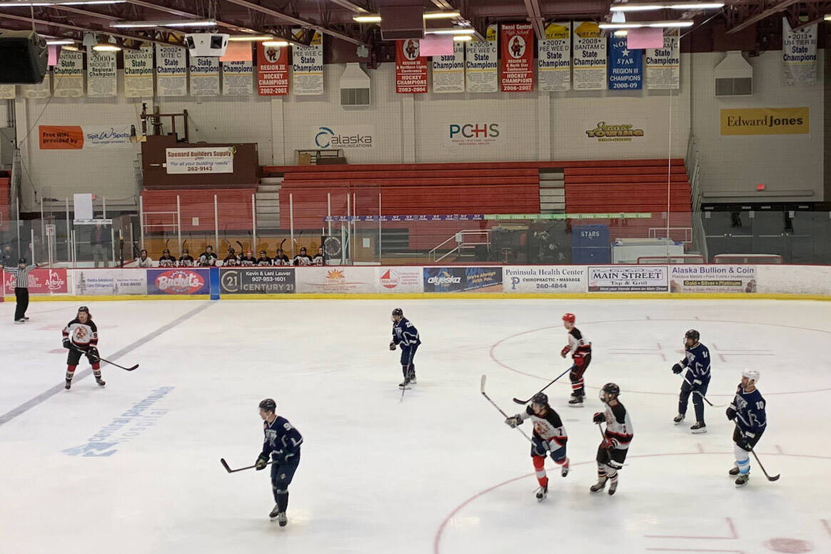 Lower left: 2023 Kenai Central High School alum Gavin Langham (#18) and 2021 Soldotna High School alum Dylan Walton battle over the puck in the second period of the annual Kenai/Nikiski and SoHi/Skyview alumni hockey game at the Soldotna Regional Sports Complex on Friday, Dec. 22, 2023, in Soldotna, Alaska. (Ashlyn O’Hara/Peninsula Clarion)