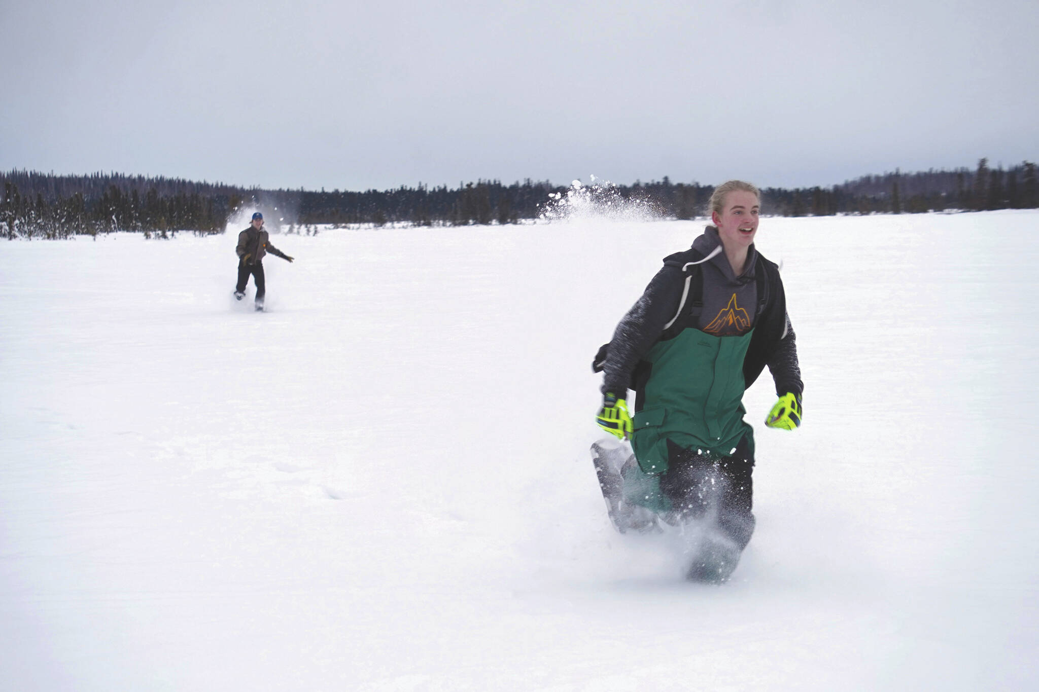 Jake Dye/Peninsula Clarion
Nathan Teates uses snowshoes to run across Headquarters Lake in the Kenai National Wildlife Refuge, pursued by Isaac Copple, near Soldotna on Saturday.