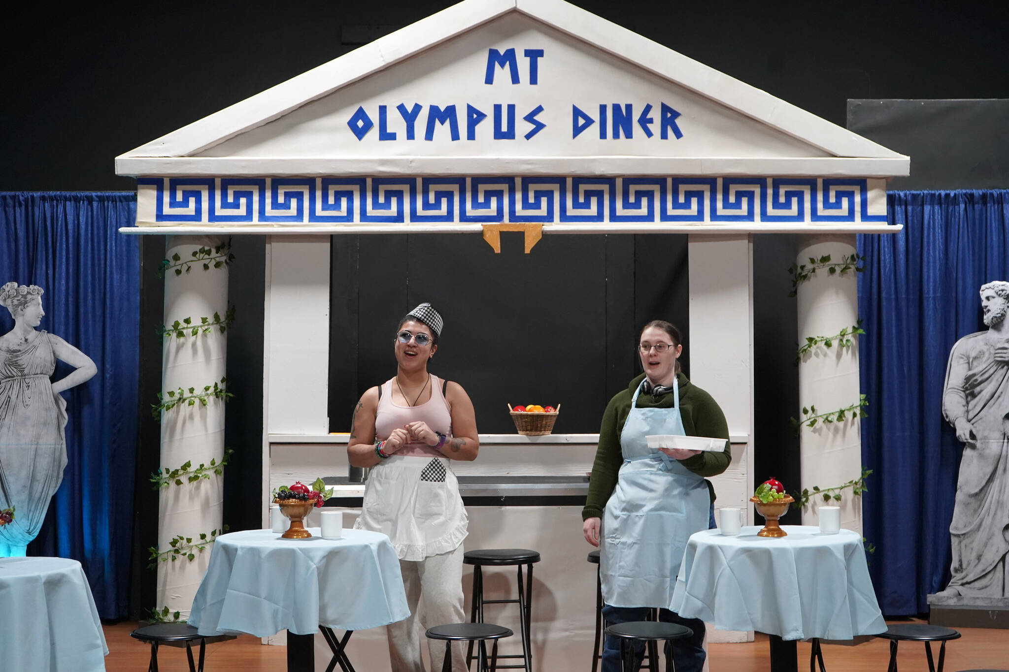 Kassándra Feltman portrays Pandora and Heather Prisk portrays Cassandra during a rehearsal of “Greece is the Word: The Zeusical” at the Kenai Performers’ Theatre in Soldotna, Alaska, on Saturday, Jan. 6, 2024. (Jake Dye/Peninsula Clarion)